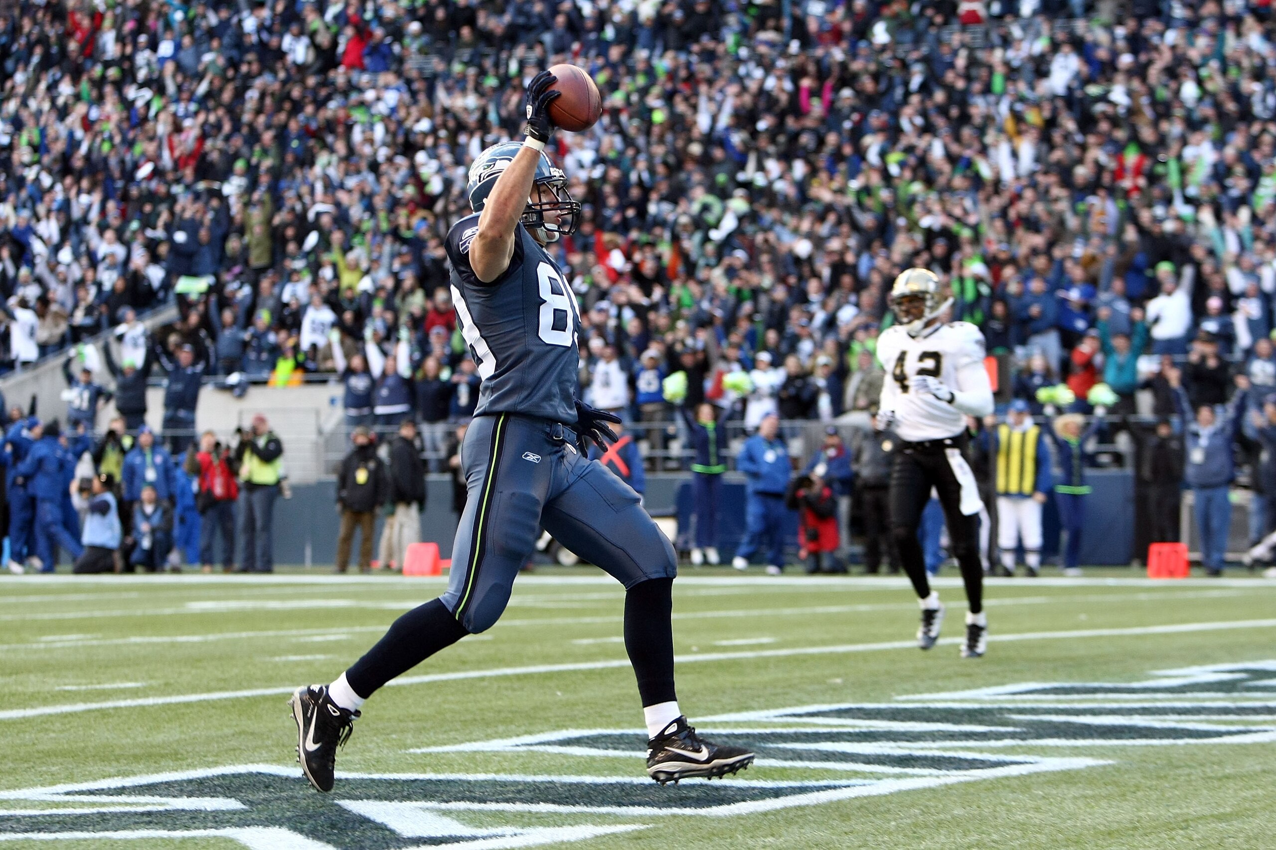 SEATTLE, WA - JANUARY 08:  Tight end John Carlson #89 of the Seattle Seahawks celebrates his 11-yard touchdown reception in the first quarter against the New Orleans Saints during the 2011 NFC wild-card playoff game at Qwest Field on January 8, 2011 in Se