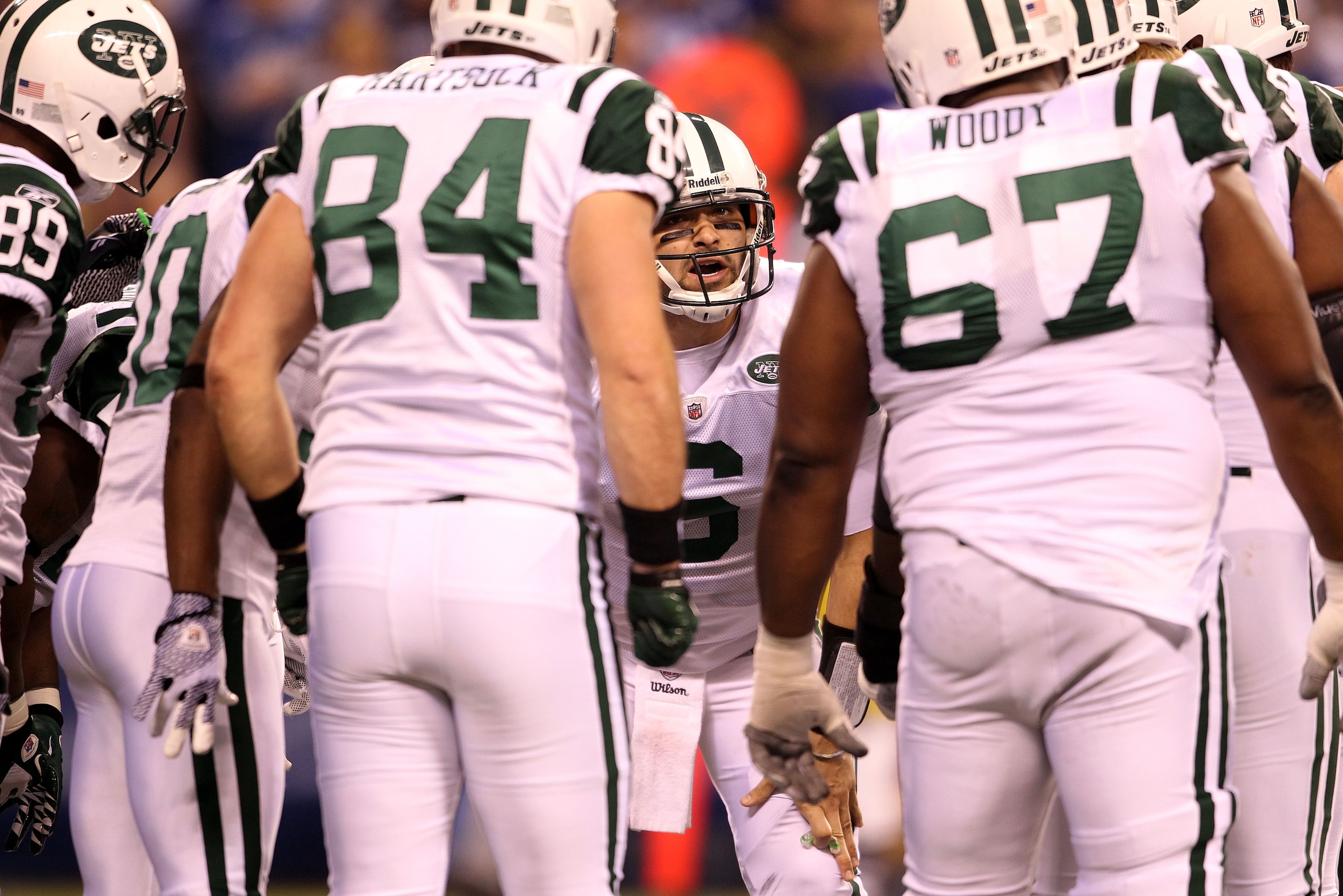 INDIANAPOLIS, IN - JANUARY 08:  Mark Sanchez #6 of  the New York Jets calls a play in the huddle against the Indianapolis Colts during their 2011 AFC wild card playoff game at Lucas Oil Stadium on January 8, 2011 in Indianapolis, Indiana. The Jets won 17-