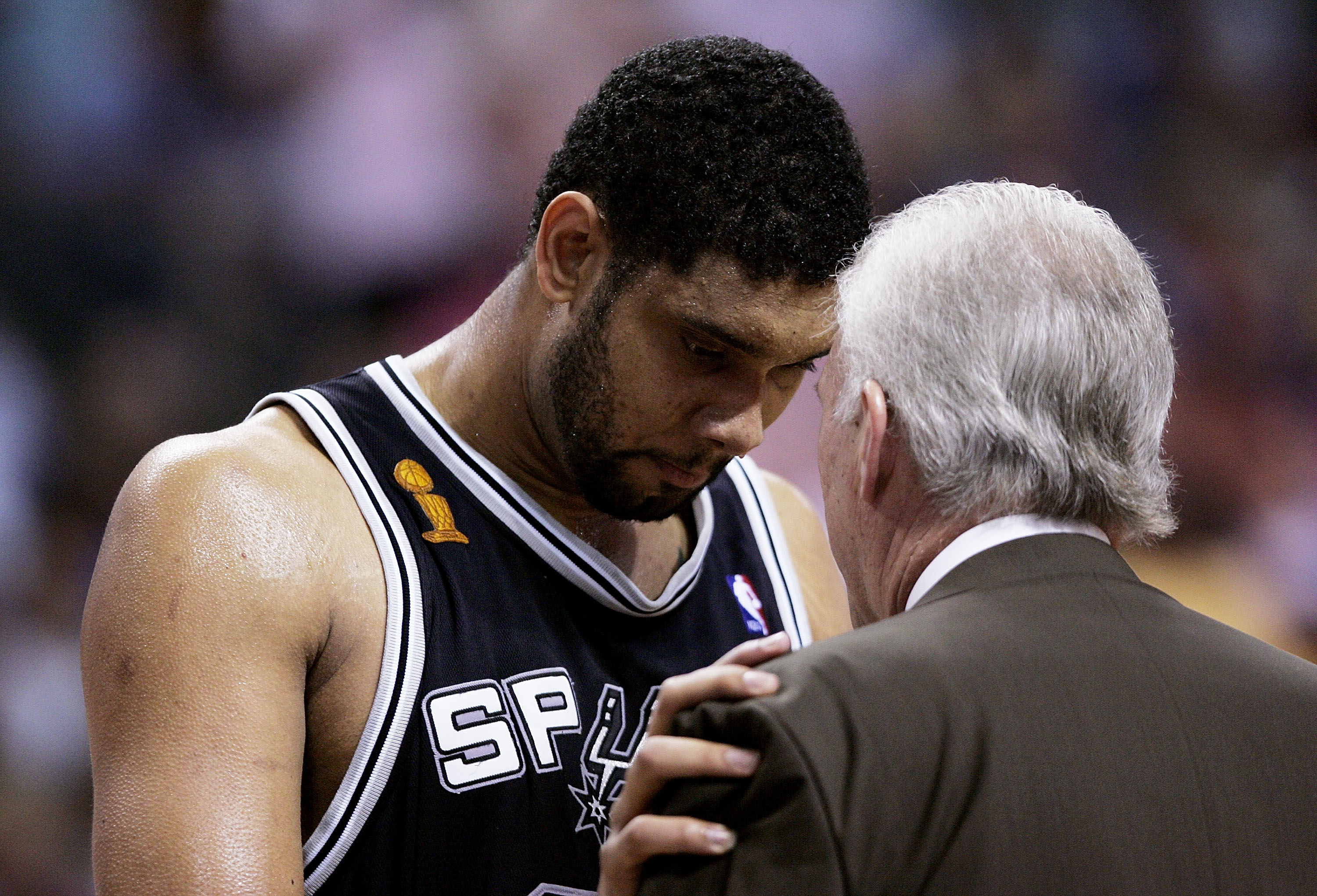 AUBURN HILLS, MI - JUNE 19:  Tim Duncan #21 of the San Antonio Spurs has a one-on-one talk with head coach Gregg Popovich in the first half against the Detroit Pistons in Game five of the 2005 NBA Finals at The Palace of Auburn Hills on June 19, 2005 in A