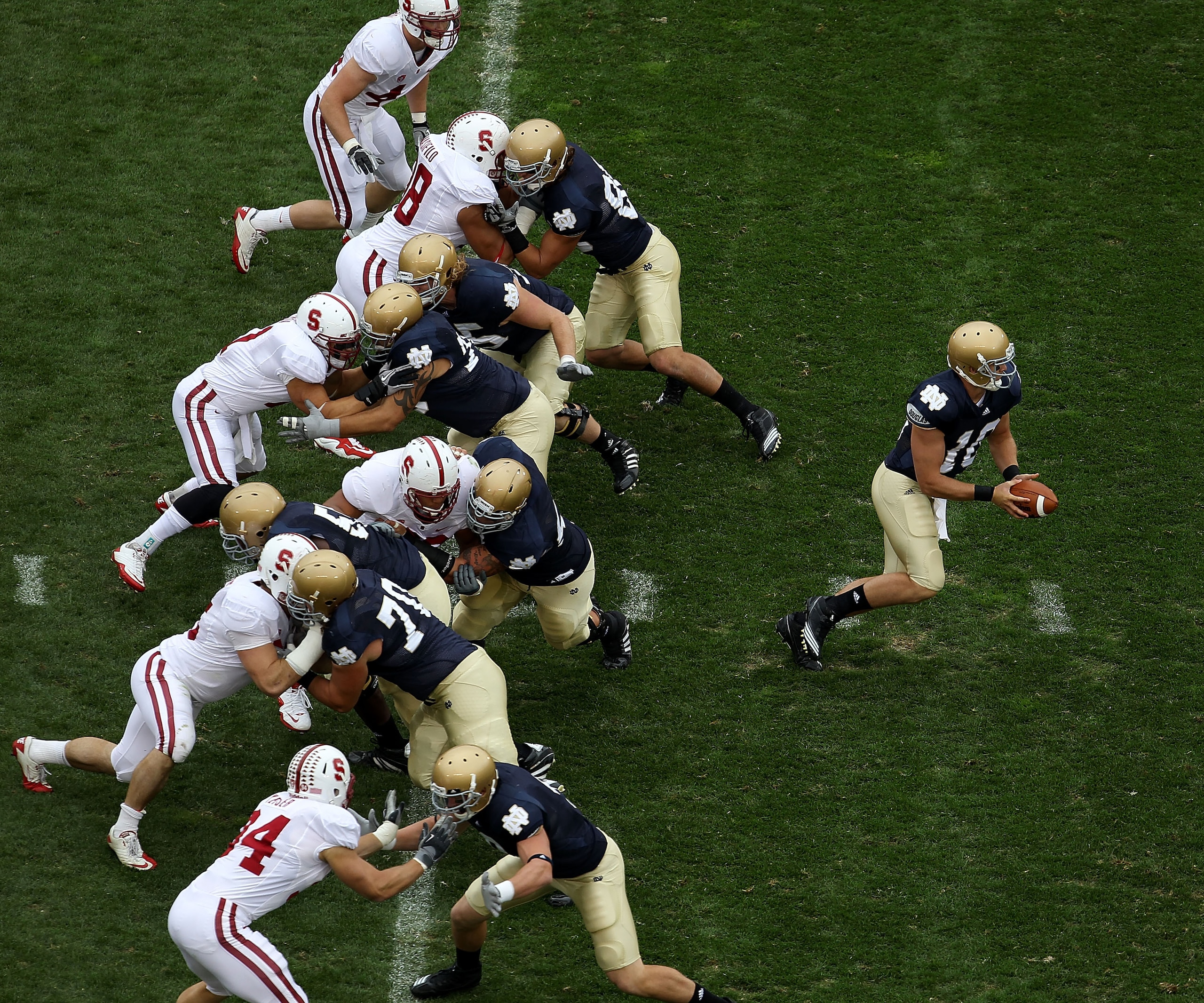 SOUTH BEND, IN - SEPTEMBER 25: Dayne Crist #10 of the Notre Dame Fighting Irish turns to hand-off as his offensive line blocks against the Stanford Cardinal defense at Notre Dame Stadium on September 25, 2010 in South Bend, Indiana. Standford defeated Not