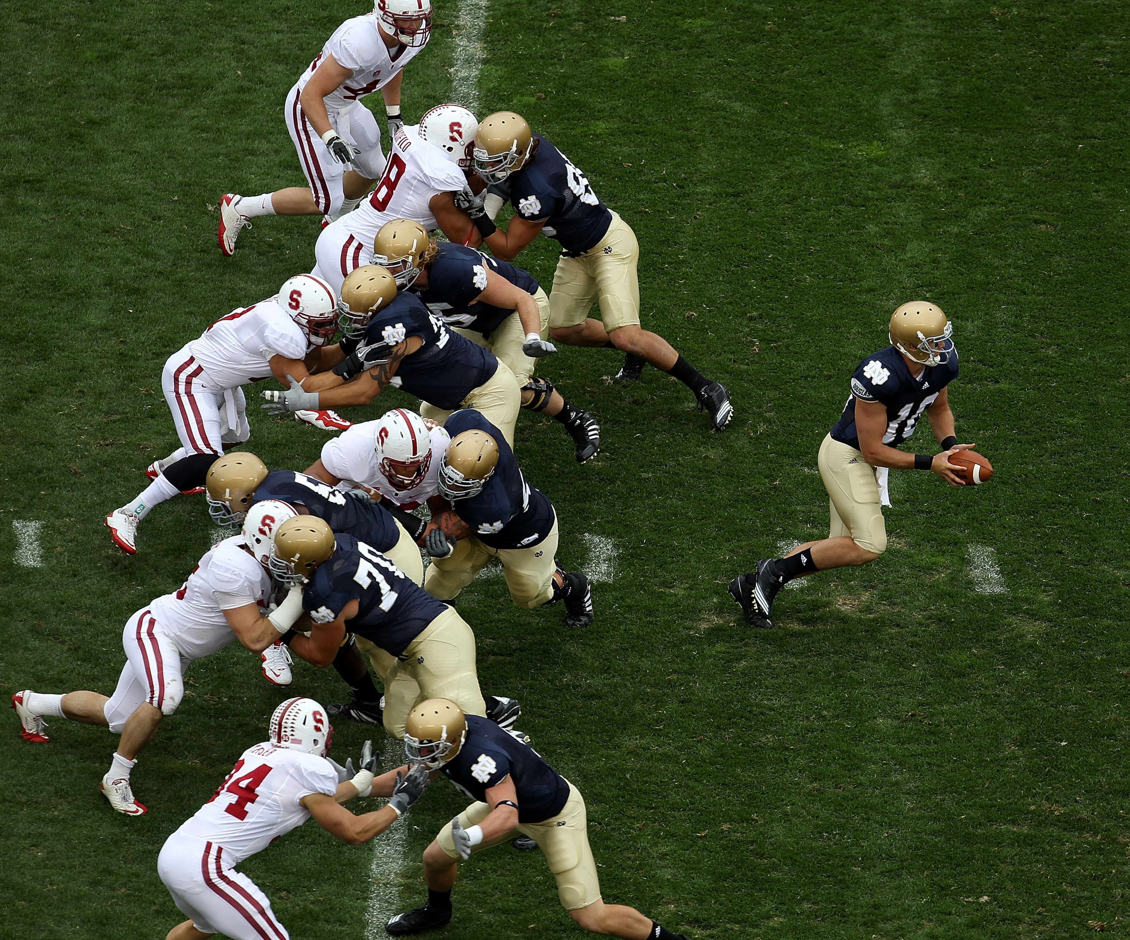 SOUTH BEND, IN - SEPTEMBER 25: Dayne Crist #10 of the Notre Dame Fighting Irish turns to hand-off as his offensive line blocks against the Stanford Cardinal defense at Notre Dame Stadium on September 25, 2010 in South Bend, Indiana. Standford defeated Not SOUTH BEND, IN - SEPTEMBER 25: Dayne Crist #10 of the Notre Dame Fighting Irish turns to hand-off as his offensive line blocks against the Stanford Cardinal defense at Notre Dame Stadium on September 25, 2010 in South Bend, Indiana. Standford defeated Not