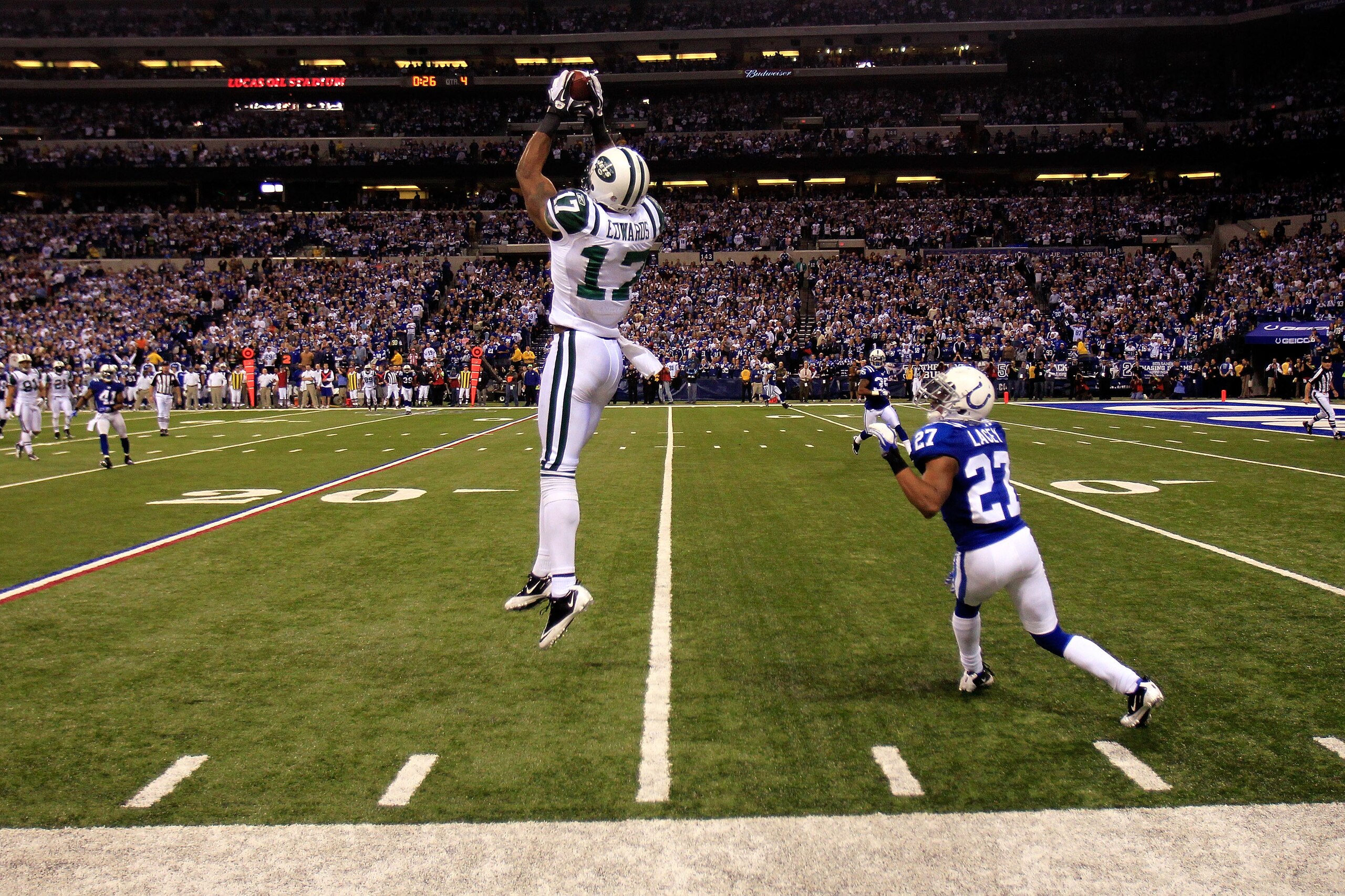 INDIANAPOLIS, IN - JANUARY 08:  Braylon Edwards #17 of the New York Jets makes an 18-yard reception in the final minute of the fourth quarter against Jacob Lacey #27 of the Indianapolis Colts during their 2011 AFC wild card playoff game at Lucas Oil Stadi