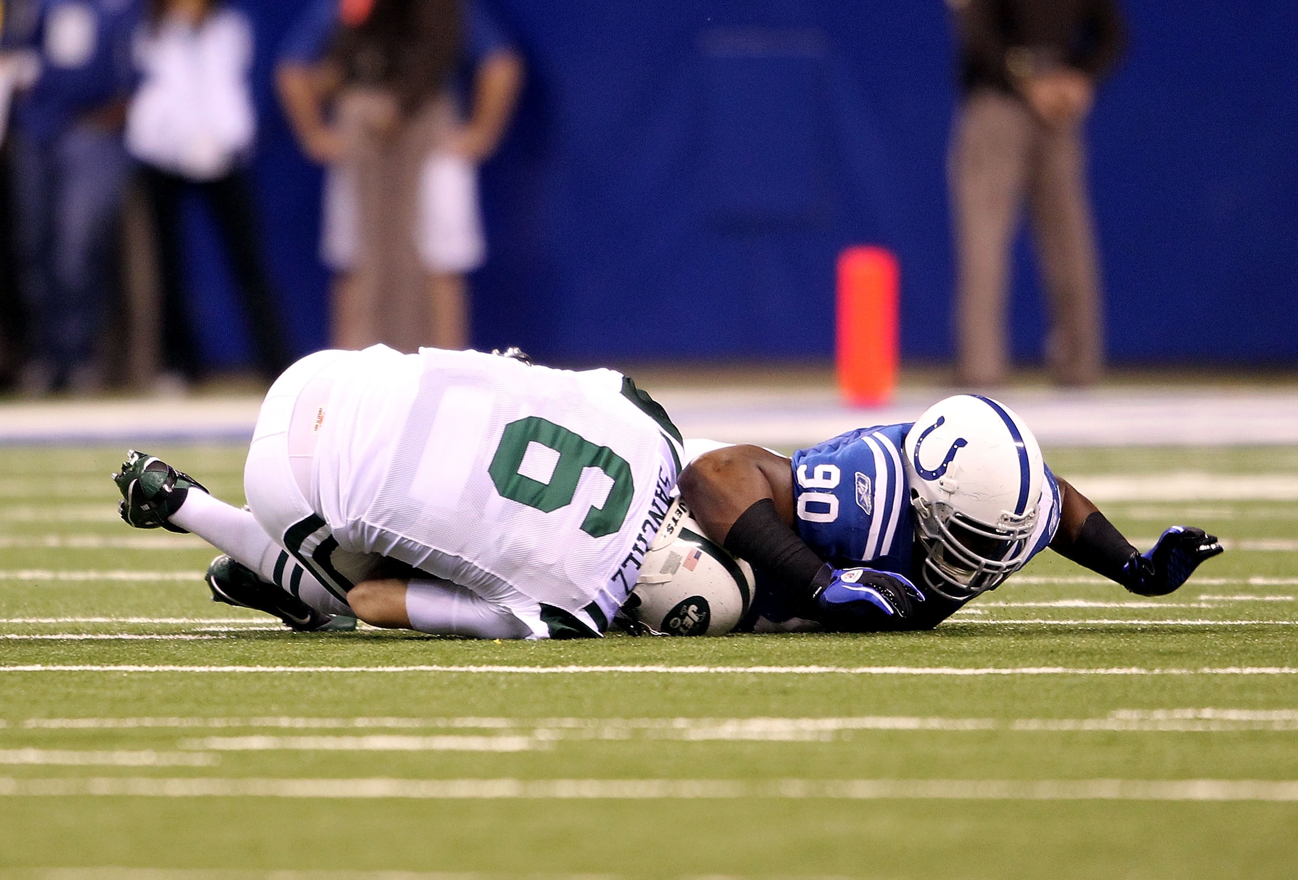 INDIANAPOLIS, IN - JANUARY 08:  Dan Muir #90 of the Indianapolis Colts sacks quarterback Mark Sanchez #6 of the New York Jets in the first quarter during their 2011 AFC wild card playoff game at Lucas Oil Stadium on January 8, 2011 in Indianapolis, Indian