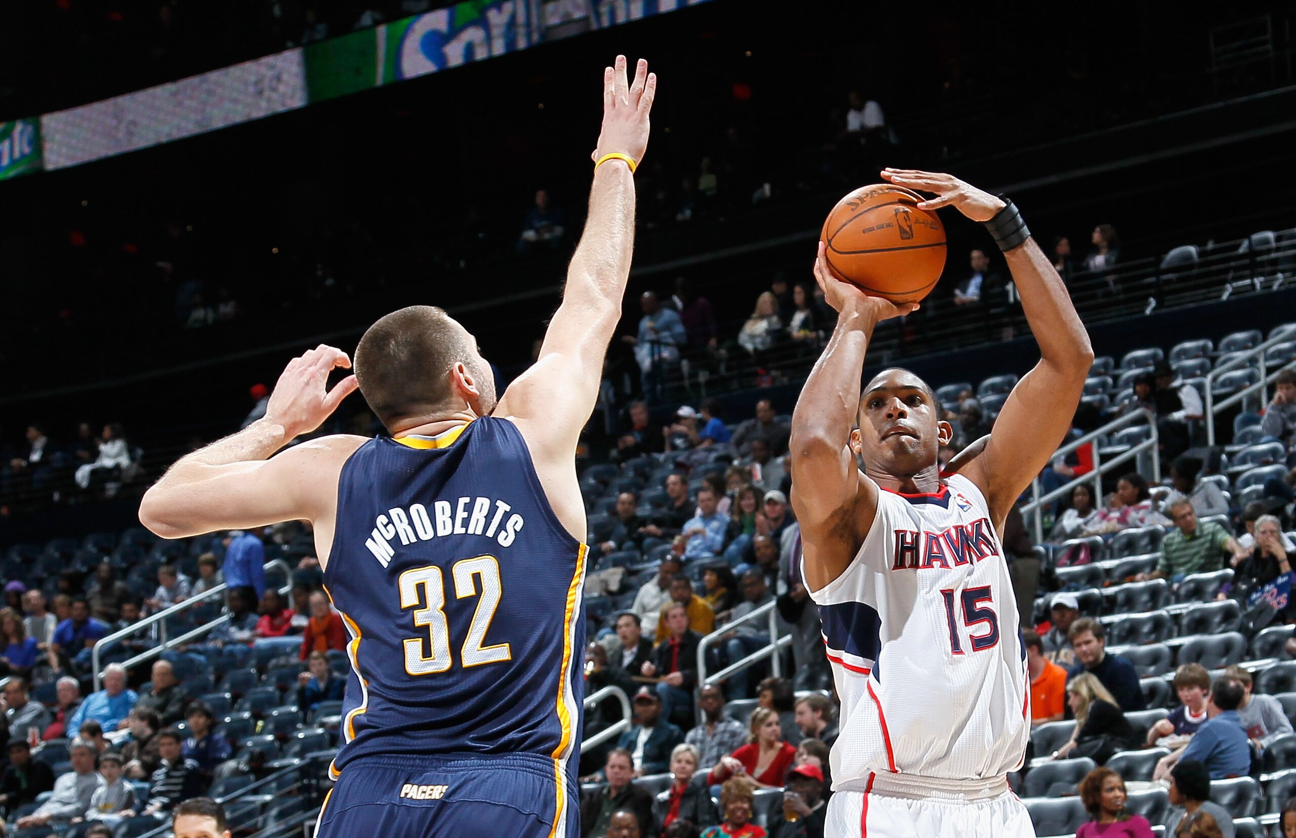ATLANTA, GA - DECEMBER 11:  Al Horford #15 of the Atlanta Hawks against Josh McRoberts #32 of the Indiana Pacers at Philips Arena on December 11, 2010 in Atlanta, Georgia.  NOTE TO USER: User expressly acknowledges and agrees that, by downloading and/or u