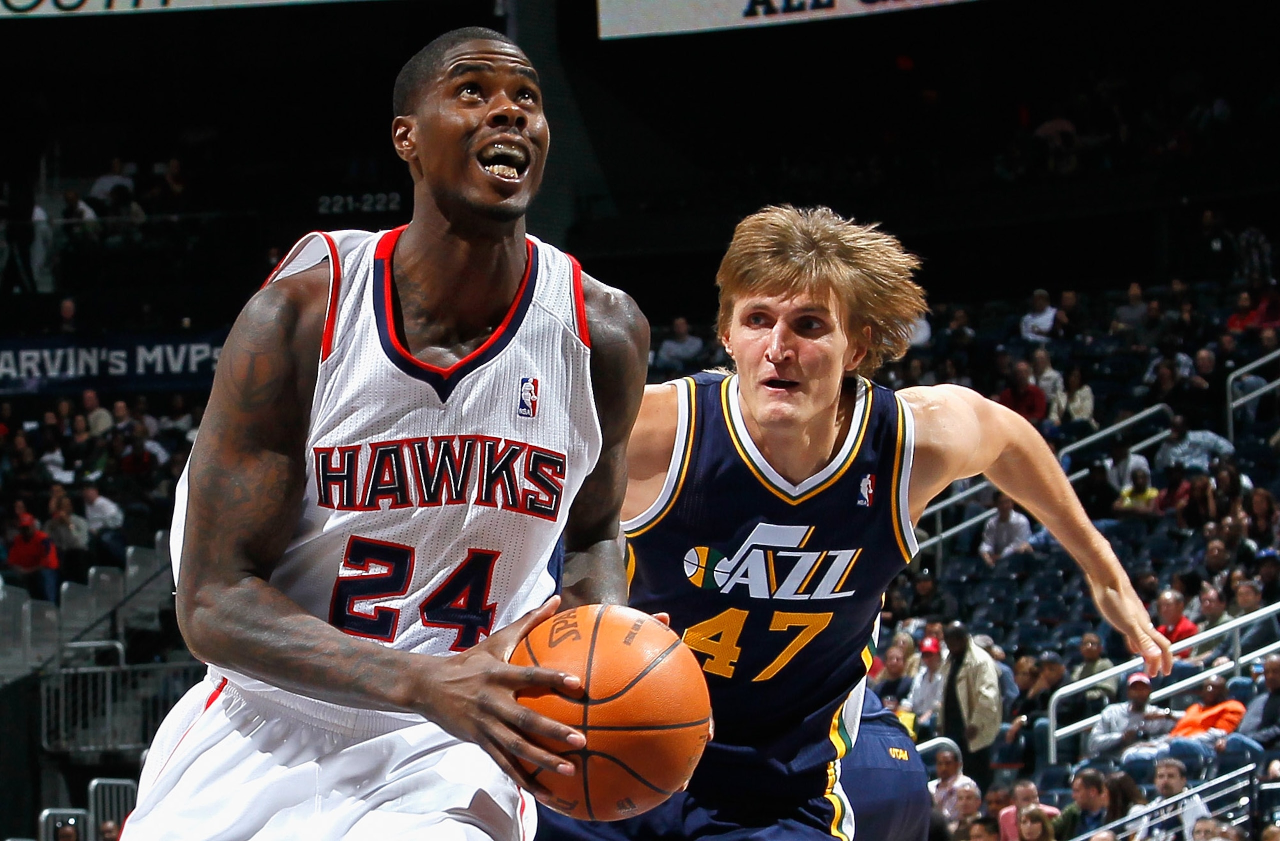 ATLANTA - NOVEMBER 12:  Marvin Williams #24 of the Atlanta Hawks drives around Andrei Kirilenko #47 of the Utah Jazz at Philips Arena on November 12, 2010 in Atlanta, Georgia.  NOTE TO USER: User expressly acknowledges and agrees that, by downloading and/