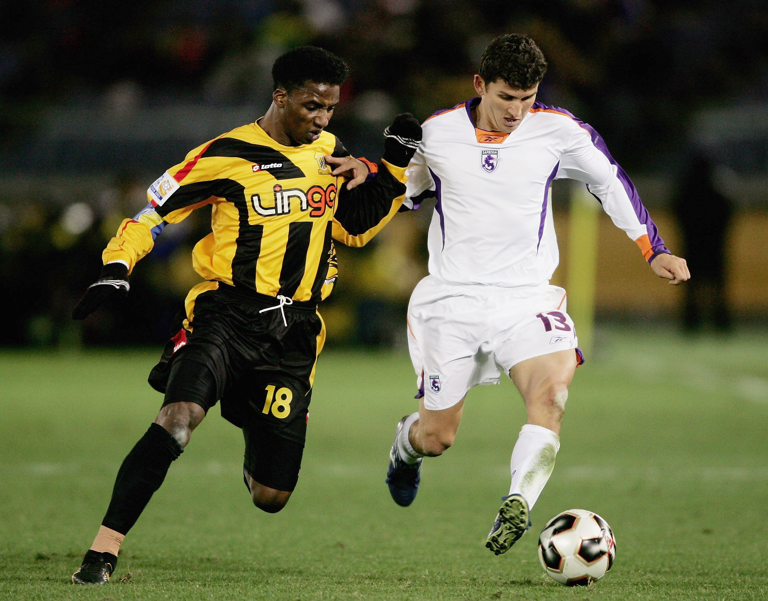 YOKOHAMA, JAPAN- DECEMBER 18: Juan Esquivel of Deportivo Saprissa is challenged by Mohammed Noor of Al Ittihad during the FIFA Club World Championship Toyota Cup 2005 3rd/4th Play-off match between Al Ittihad and Deportivo Saprissa at The Yokohama Intern