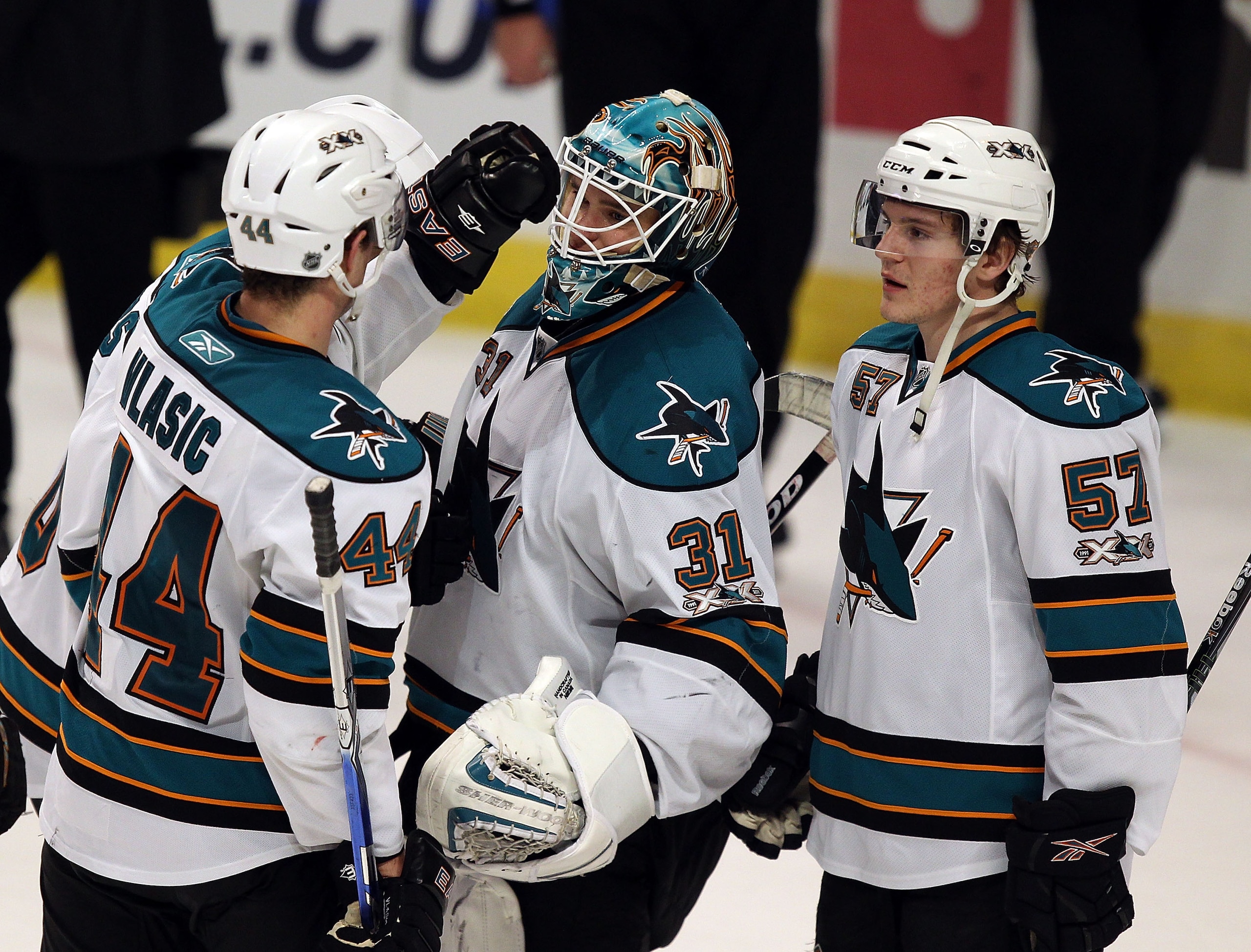 CHICAGO, IL - DECEMBER 30: Antti Niemi #31 of the San Jose Sharks is congratulated by teammates Marc-Edouard Vlasic #44 and Tommy Wingels #57 after a win over the Chicago Blackhawks at the United Center on December 30, 2010 in Chicago, Illinois. The Shark