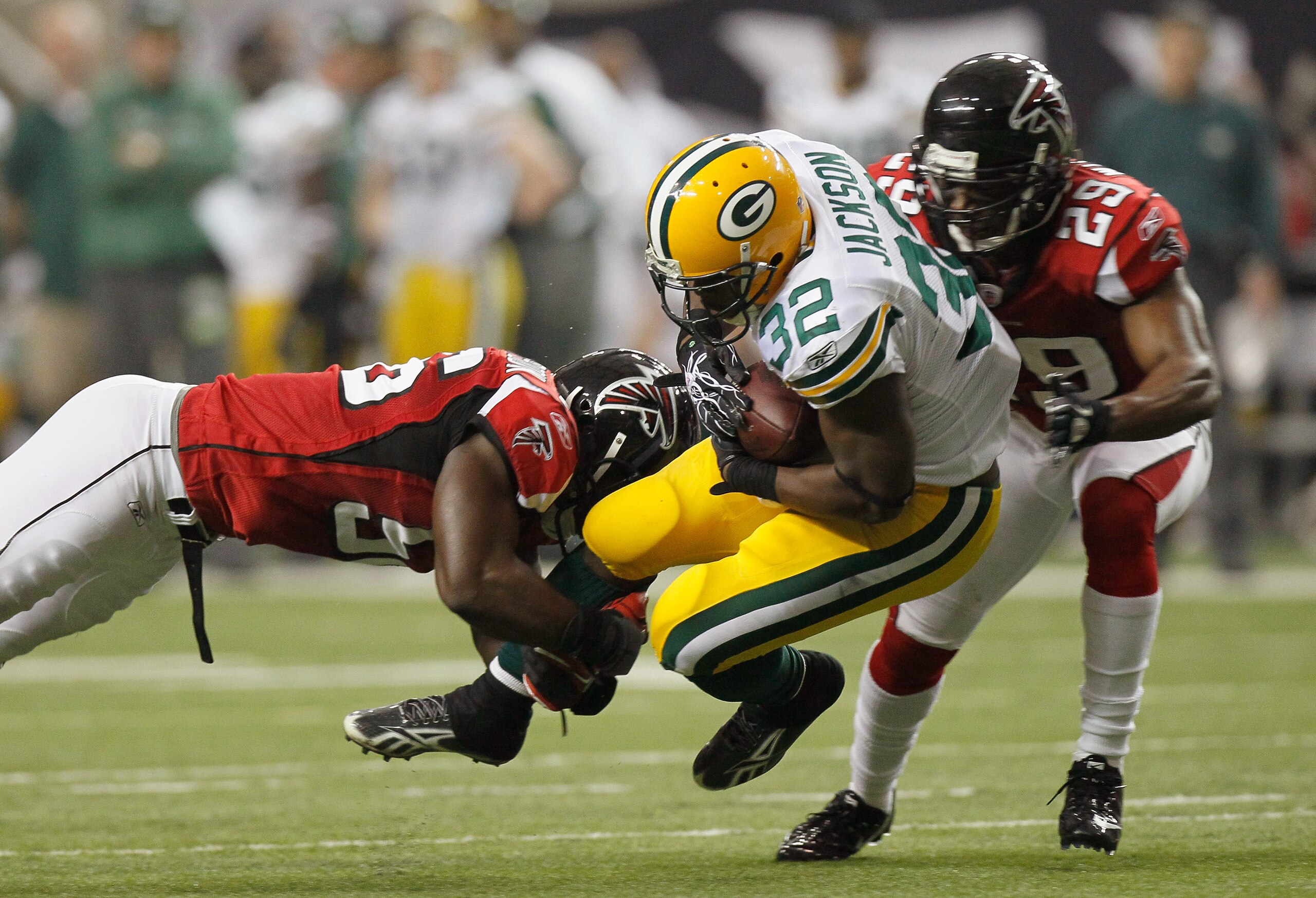 ATLANTA - NOVEMBER 28:  Sean Weatherspoon #56 and Brian Williams #29 of the Atlanta Falcons tackle Brandon Jackson #32 of the Green Bay Packers at Georgia Dome on November 28, 2010 in Atlanta, Georgia.  (Photo by Kevin C. Cox/Getty Images)
