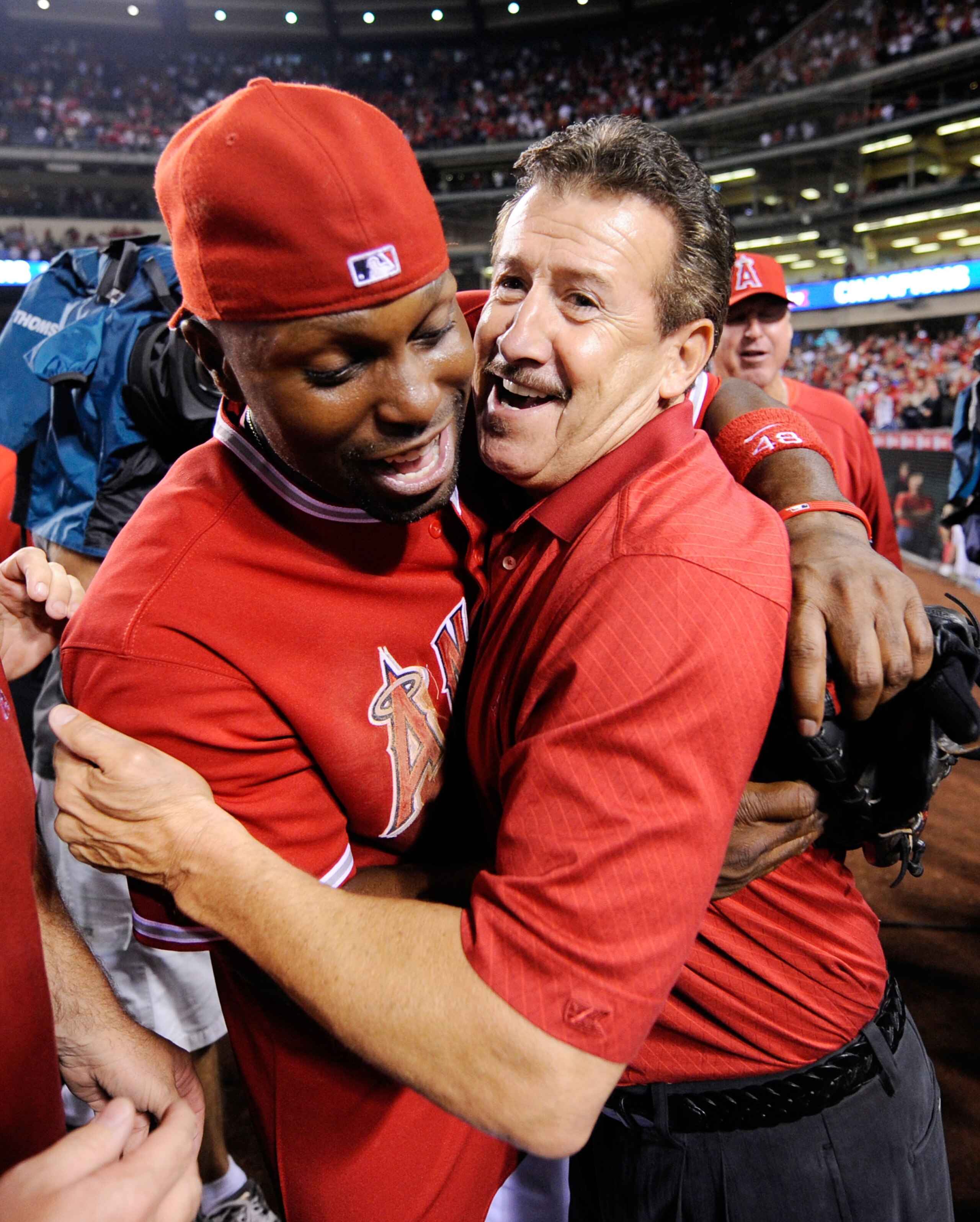 ANAHEIM, CA - SEPTEMBER 28:  Arte Moreno (R) owner of the Los Angeles Angels of Anaheim celebrates with center fielder Torii Hunter after winning the American League West title in the baseball agme against Texas Rangers at Angel Stadium on September 28, 2
