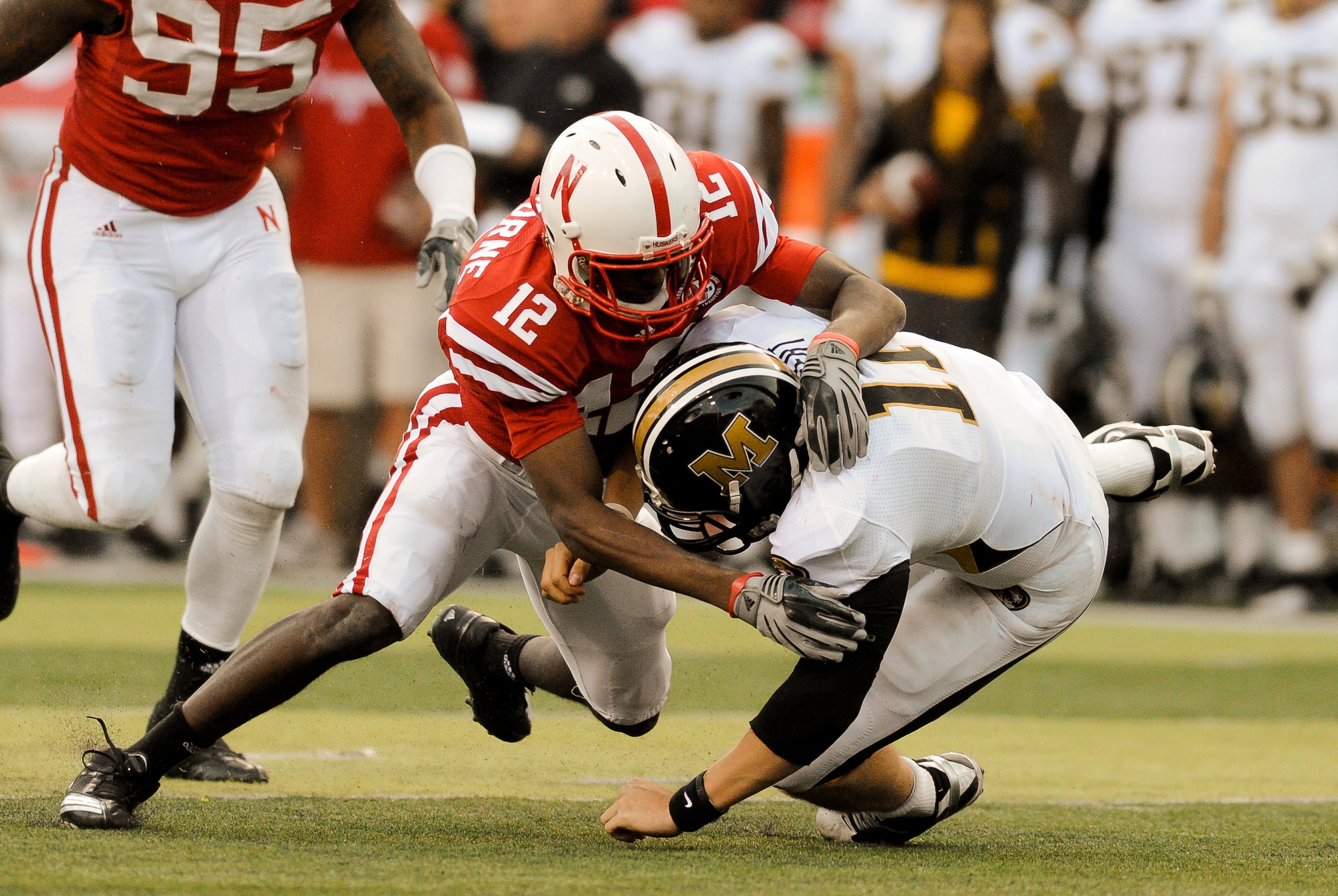 LINCOLN, NE - OCTOBER 30: Safety Courtney Osborne #12 of the Nebraska Cornhuskers hits quarterback Blaine Gabbert #11 of the Missouri Tigers during second half action of their game at Memorial Stadium on October 30, 2010 in Lincoln, Nebraska. Nebraska De LINCOLN, NE - OCTOBER 30: Safety Courtney Osborne #12 of the Nebraska Cornhuskers hits quarterback Blaine Gabbert #11 of the Missouri Tigers during second half action of their game at Memorial Stadium on October 30, 2010 in Lincoln, Nebraska. Nebraska De