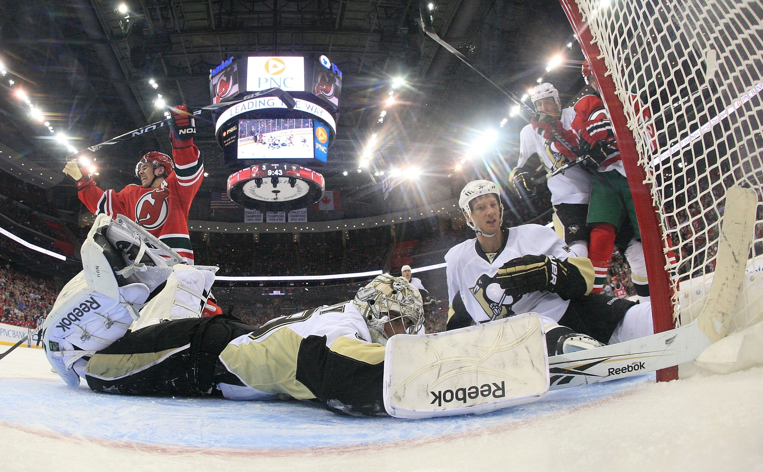 NEWARK, NJ - MARCH 17: Marc-Andre Fleury #29 of the Pittsburgh Penguins can't stop a shot by Zach Parise #9 (L) of the New Jersey Devils at the Prudential Center on March 17, 2010 in Newark, New Jersey.  (Photo by Bruce Bennett/Getty Images)