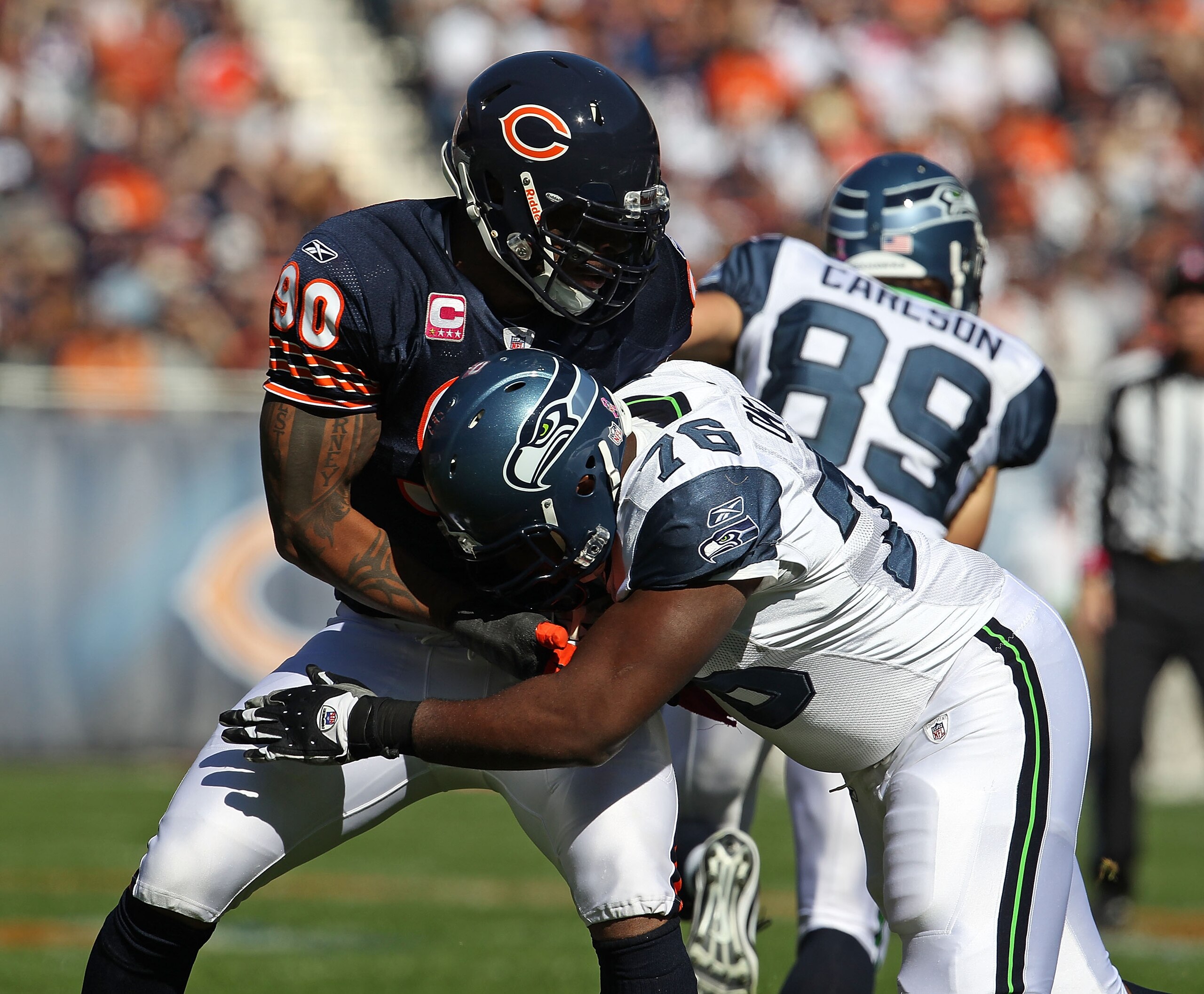 CHICAGO - OCTOBER 17: Julius Peppers #90 of the Chicago Bears rushes against Russell Okung #76 of the Seattle Seahawks at Soldier Field on October 17, 2010 in Chicago, Illinois. The Seahawks defeated the Bears 23-20. (Photo by Jonathan Daniel/Getty Images