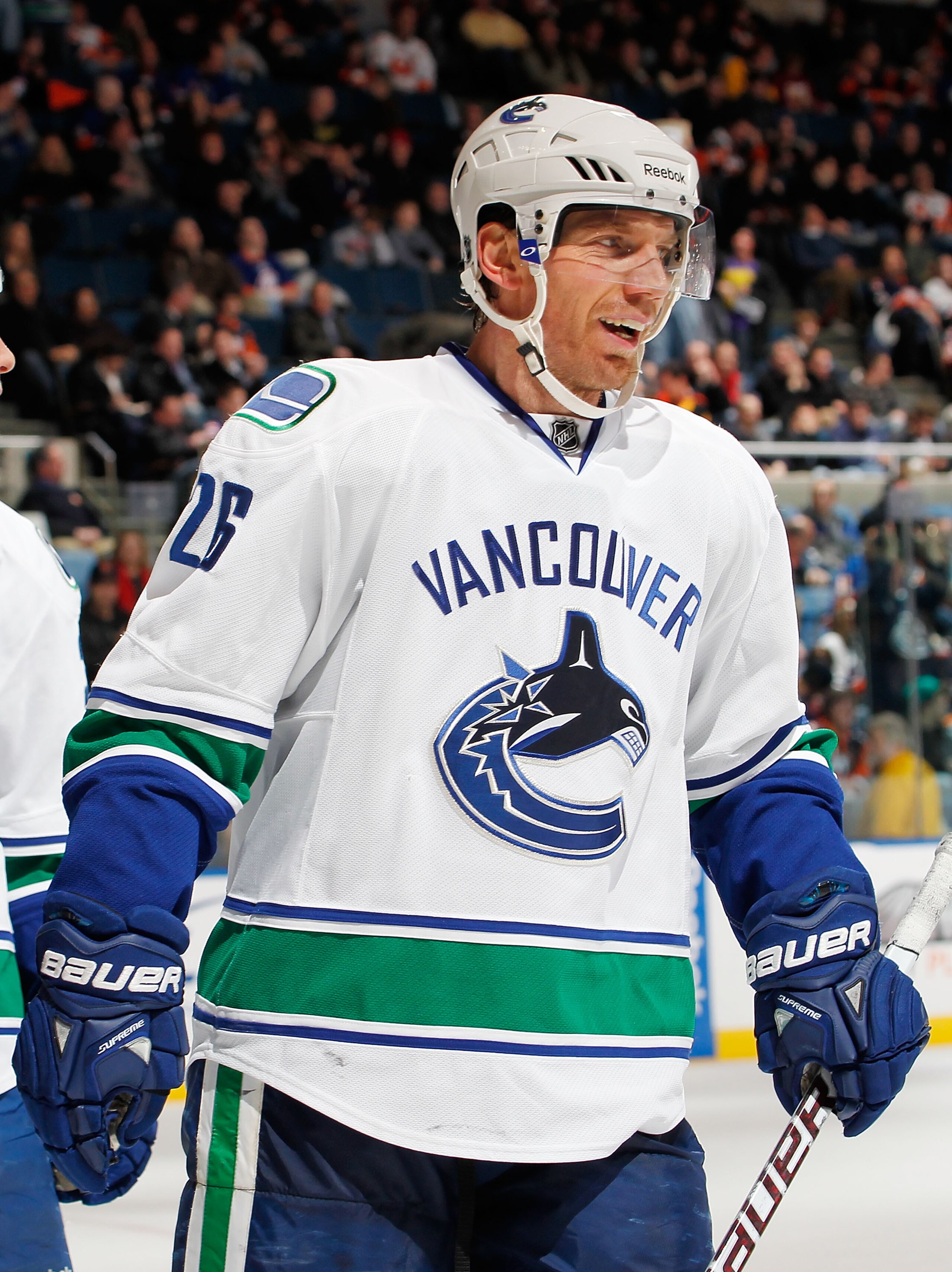 UNIONDALE, NY - JANUARY 11:  Mikael Samuelsson #26 of the Vancouver Canucks  sksmiles after a Vancouver goal during an NHL game against the New York Islanders at Nassau Coliseum on January 11, 2011 in Uniondale, New York.  (Photo by Paul Bereswill/Getty I