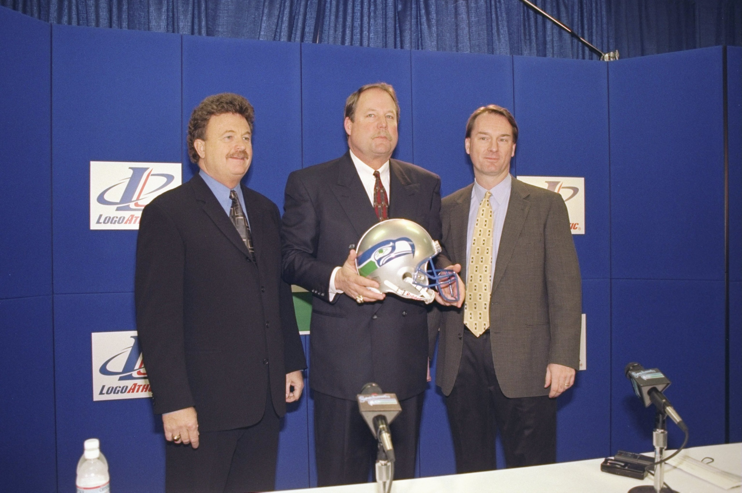 8 Jan 1999: New Head Coach Mike Holmgren of the Seattle Seahawks stands in between Bob Lamonte and Bob Whitsitt holding a Seattle Seahawks helmet during the Seahawks Press Conference in Seattle, Washington. 8 Jan 1999: New Head Coach Mike Holmgren of the Seattle Seahawks stands in between Bob Lamonte and Bob Whitsitt holding a Seattle Seahawks helmet during the Seahawks Press Conference in Seattle, Washington.