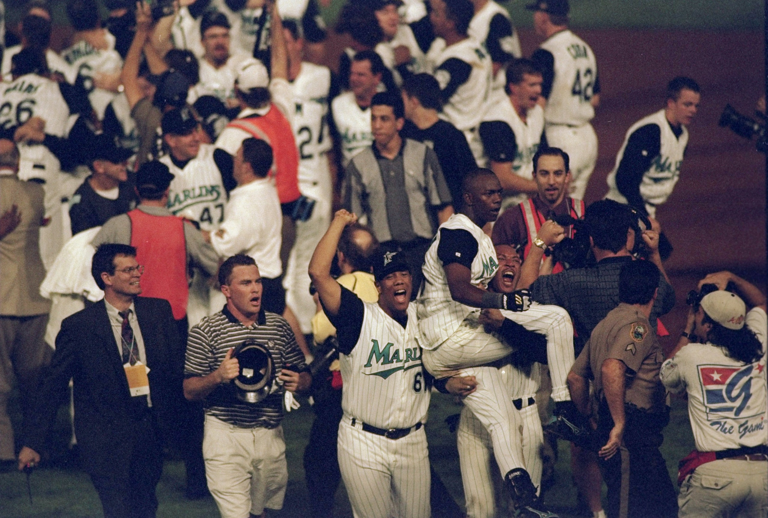 26 Oct 1997:   Shortstop Edgar Renteria of the Florida Marlins is carried by teammates outfielder Gary Sheffield and pitcher Livan Hernandez  after 11 innings of the 7th game of the 1997 World Series against the Cleveland Indians at Pro Player Stadium in