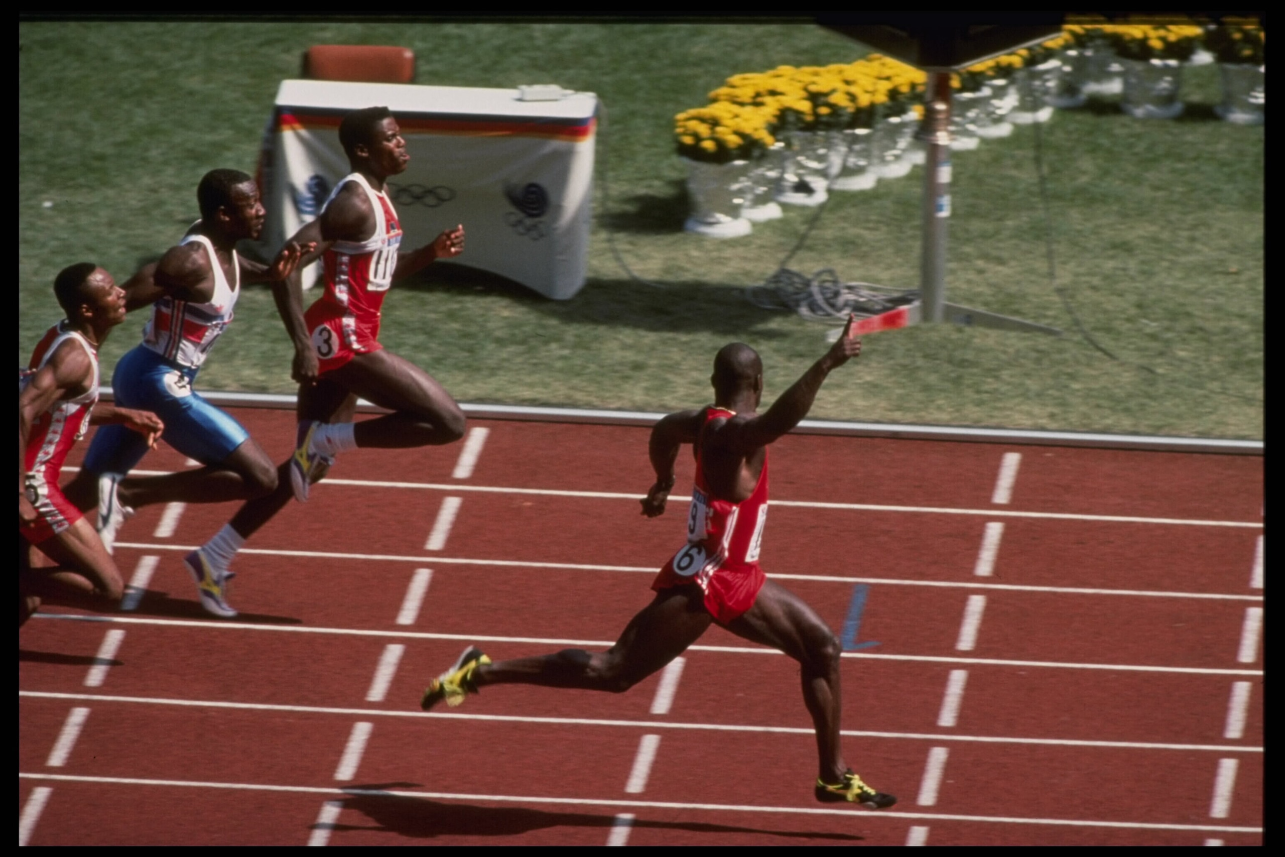 24 Sep 1988:  Ben Johnson of Canada celebrates as he crosses the finish line well ahead of Carl Lewis of the USA and Linford Christie of Great Britain to win the mens 100m final during the 1988 Summer Olympic Games in Seoul, South Korea.  Johnson won theg