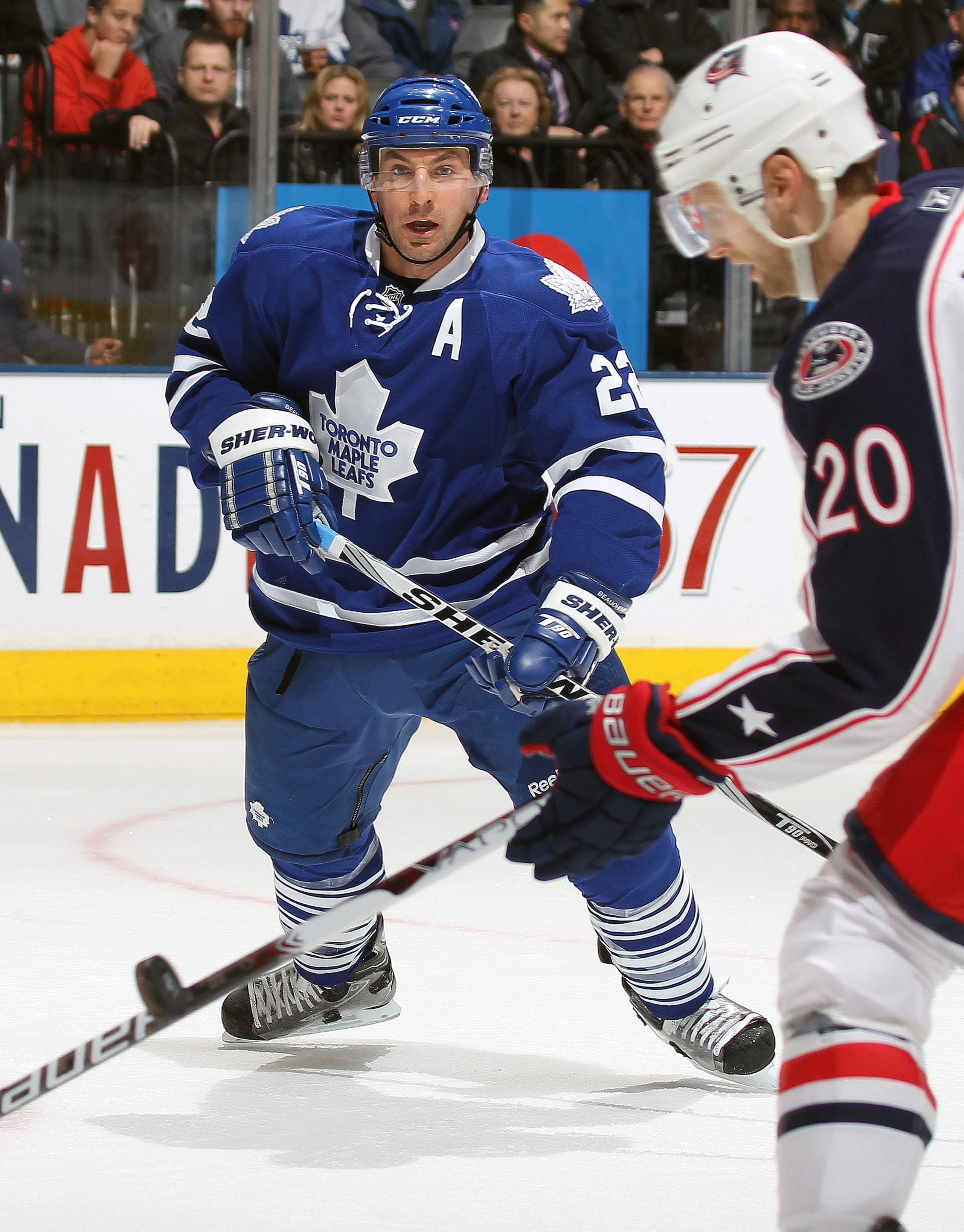 TORONTO,CAN - DECEMBER 30:  Francois Beauchemin #22 of the Toronto Maple Leafs watches a loose puck off the stick off Kristian Huselius #20 of the Columbus Blue Jackets in a game on December 30, 2010 at the Air Canada Centre in Toronto, Canada. (Photo by 