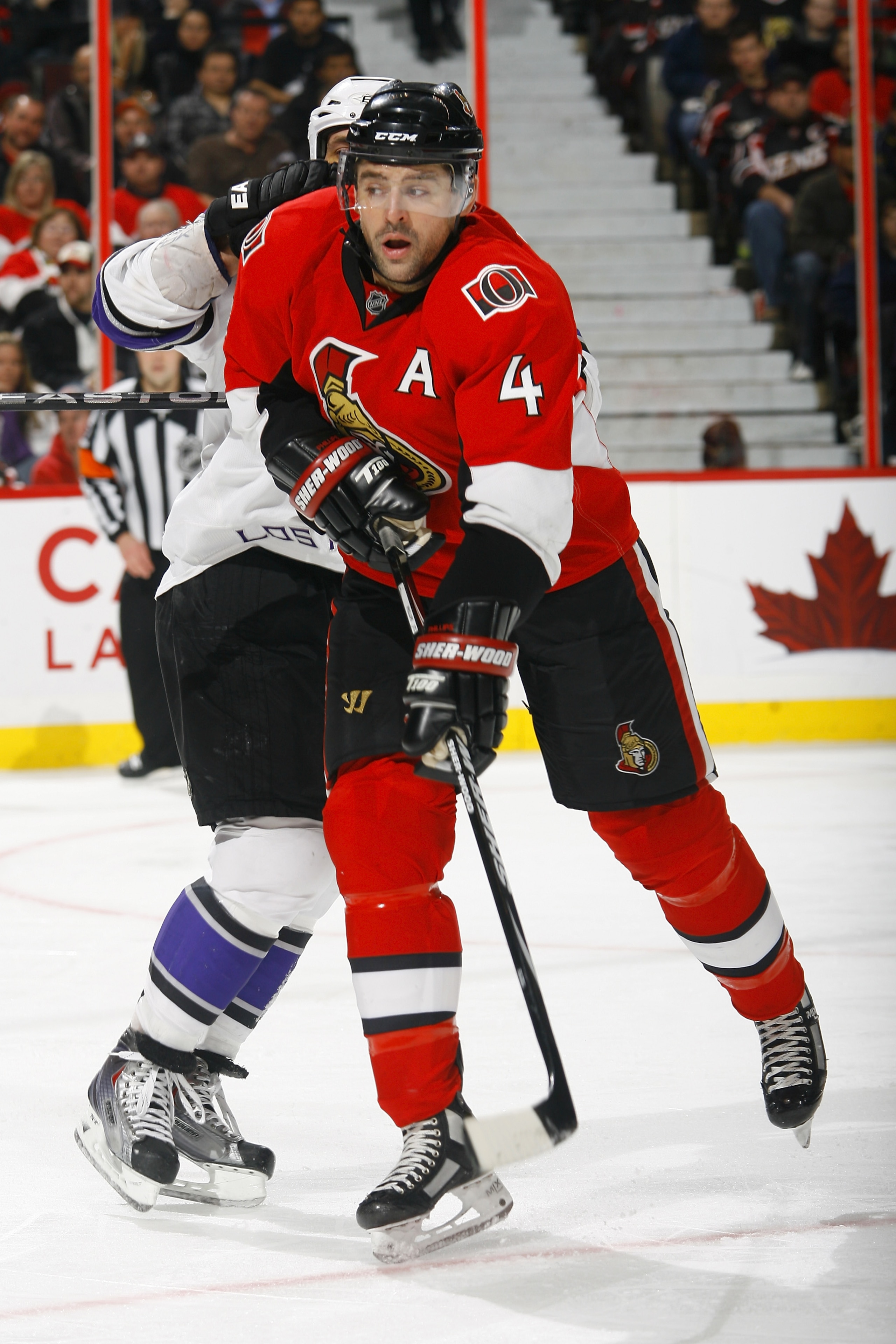 OTTAWA, ON - NOVEMBER 22:  Chris Phillips #4 of the Ottawa Senators throws the shoulder into Jarret Stoll #28 of the Los Angeles Kings during a game at Scotiabank Place on November 22, 2010 in Ottawa, Ontario, Canada.  (Photo by Phillip MacCallum/Getty Im