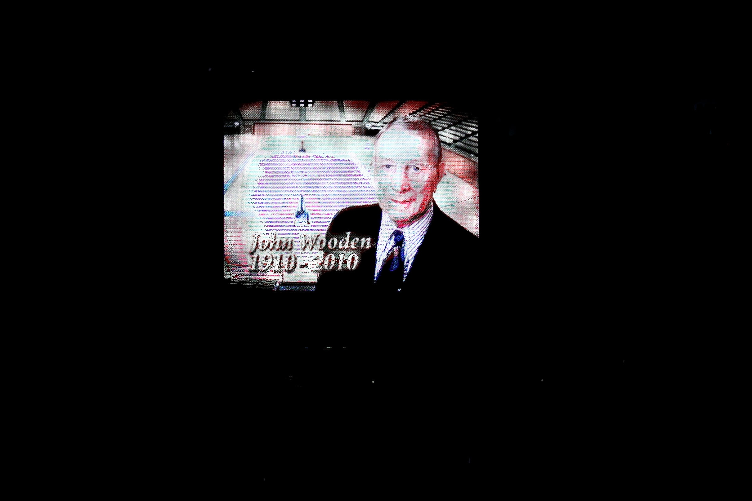 LOS ANGELES, CA - JUNE 06:  The likeness of John Wooden, former UCLA men's head basketball coach, is seen on a video board during a moment of silence in memory of Wooden, who passed away on June 4, prior to the Boston Celtics playing against the Los Angel