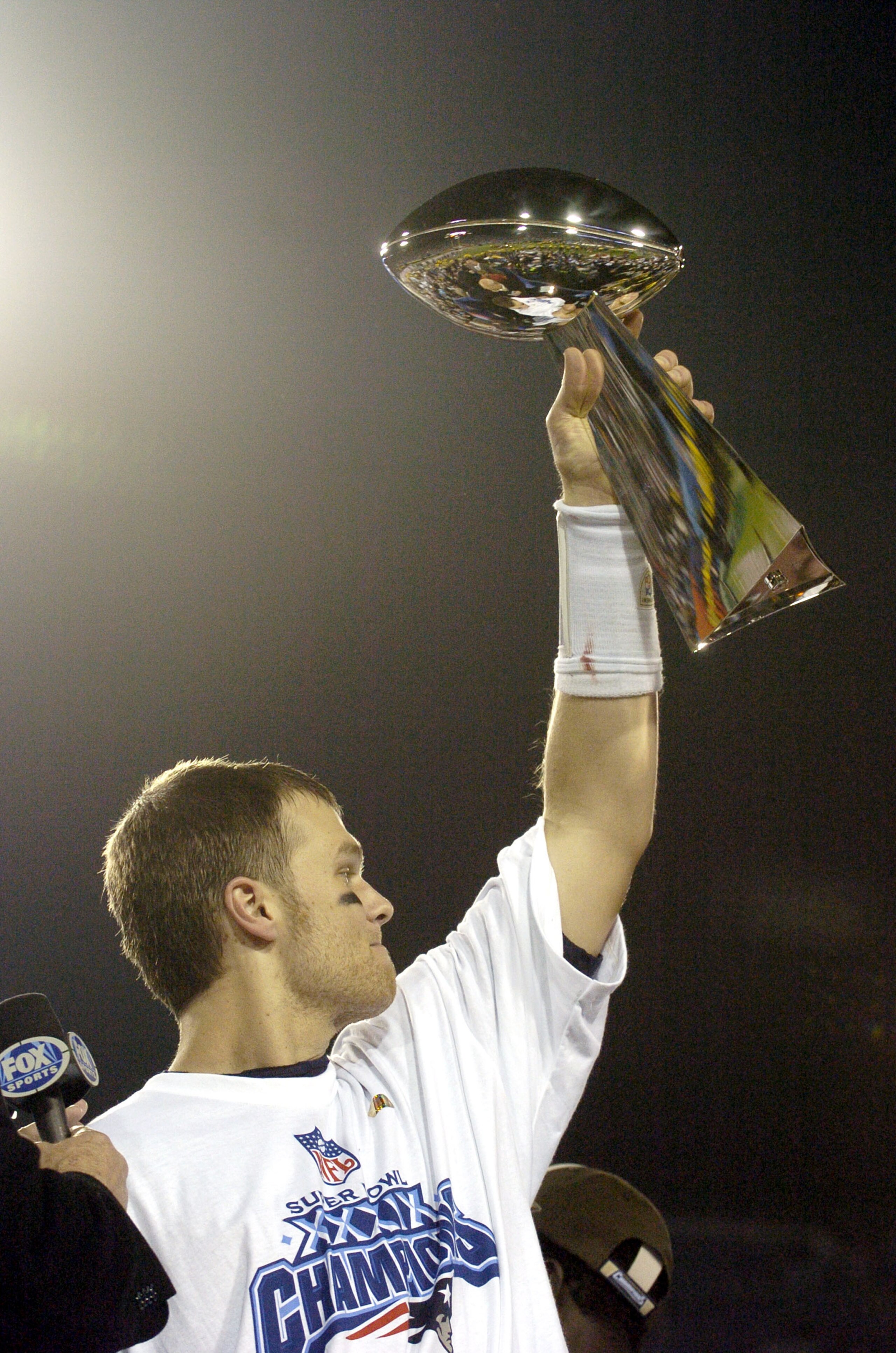 Tom Brady holds the Vince Lombardi Trophy as he stands on the podium after The New England Patriots defeated The Philadelphia Eagles in Super Bowl XXXIX at Alltel Staduim in Jacksonville, Florida. (Photo by Al Messerschmidt/Getty Images) Tom Brady holds the Vince Lombardi Trophy as he stands on the podium after The New England Patriots defeated The Philadelphia Eagles in Super Bowl XXXIX at Alltel Staduim in Jacksonville, Florida. (Photo by Al Messerschmidt/Getty Images)