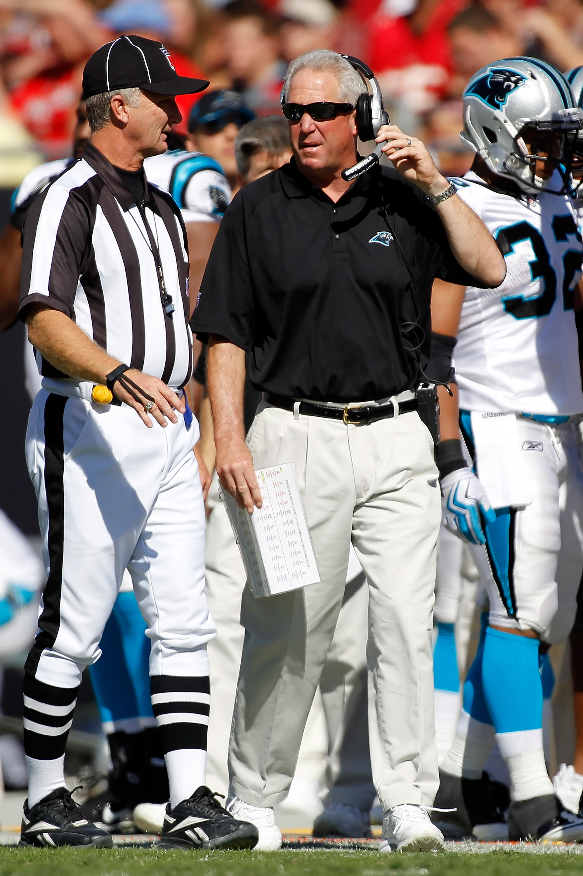 Carolina Panthers coach John Fox, left, helps draft choice Julius