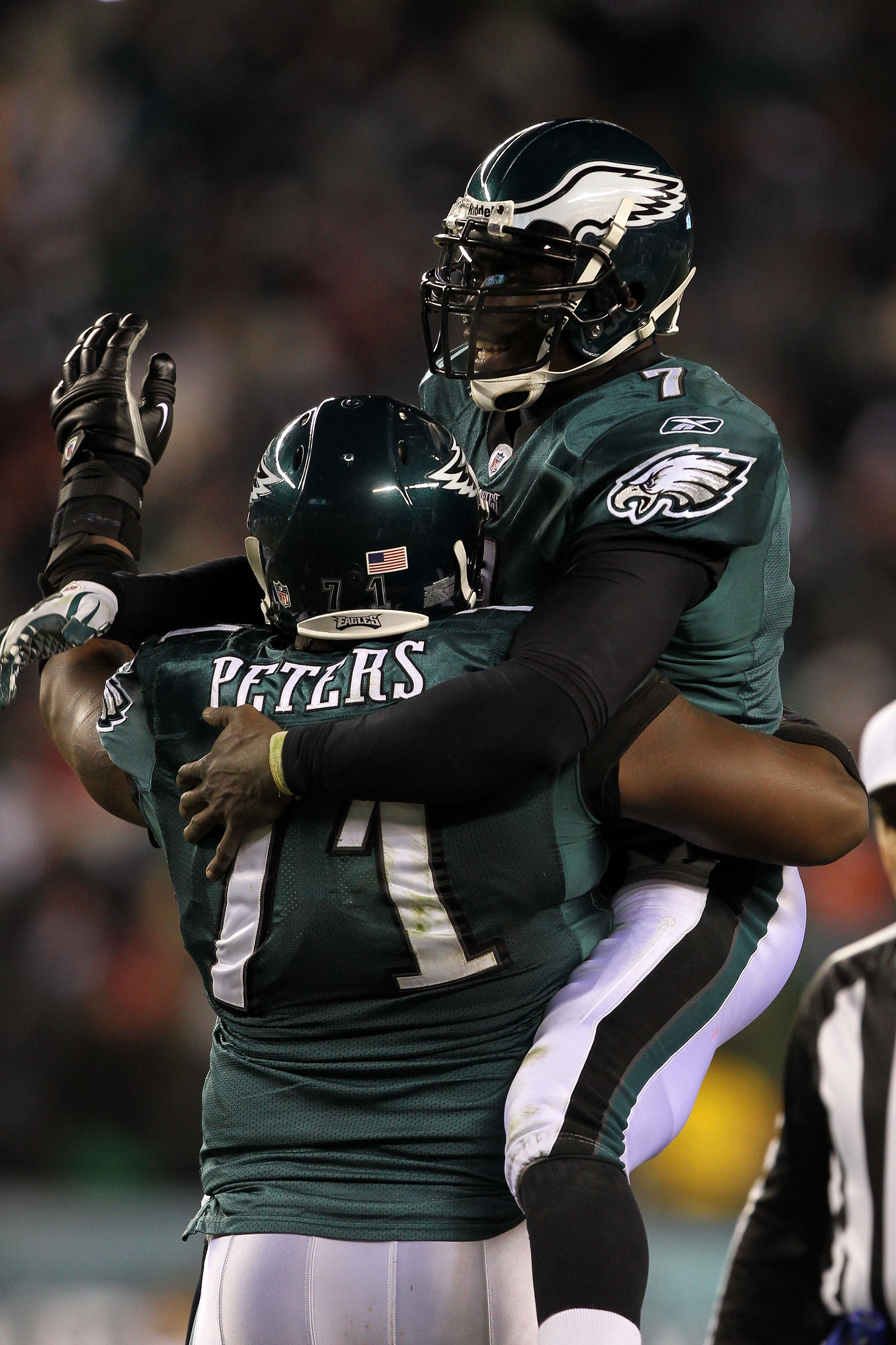 PHILADELPHIA, PA - JANUARY 09:  Michael Vick #7 of the Philadelphia Eagles celebrates with Jason Peters #71 after a touchdown in the thrid quarter against the Green Bay Packers during the 2011 NFC wild card playoff game at Lincoln Financial Field on Janua
