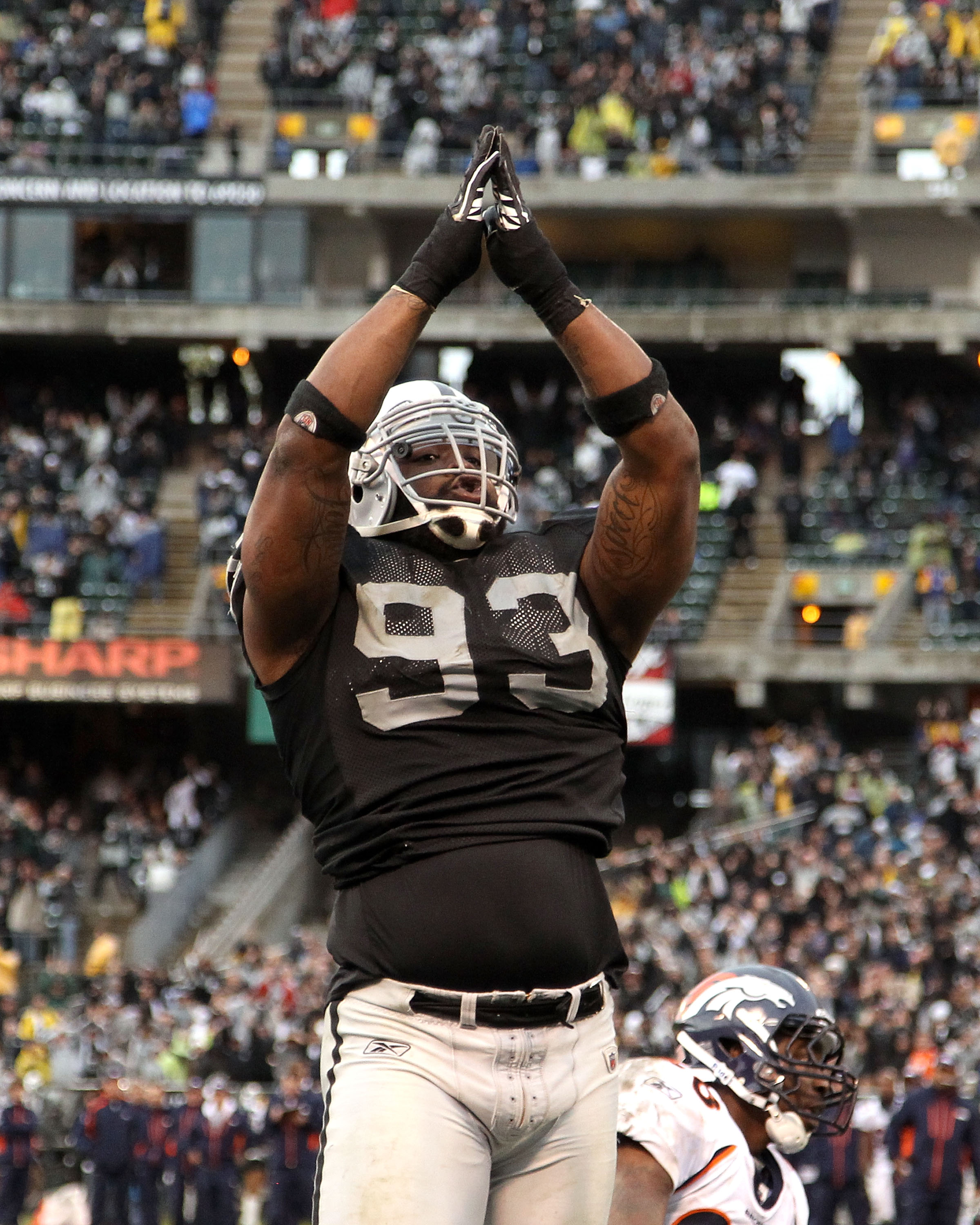 OAKLAND, CA - DECEMBER 19:  Tommy Kelly #93 of the Oakland Raiders celebrates after the Raiders scored a safety during their game against the Denver Broncos at Oakland-Alameda County Coliseum on December 19, 2010 in Oakland, California.  (Photo by Ezra Sh