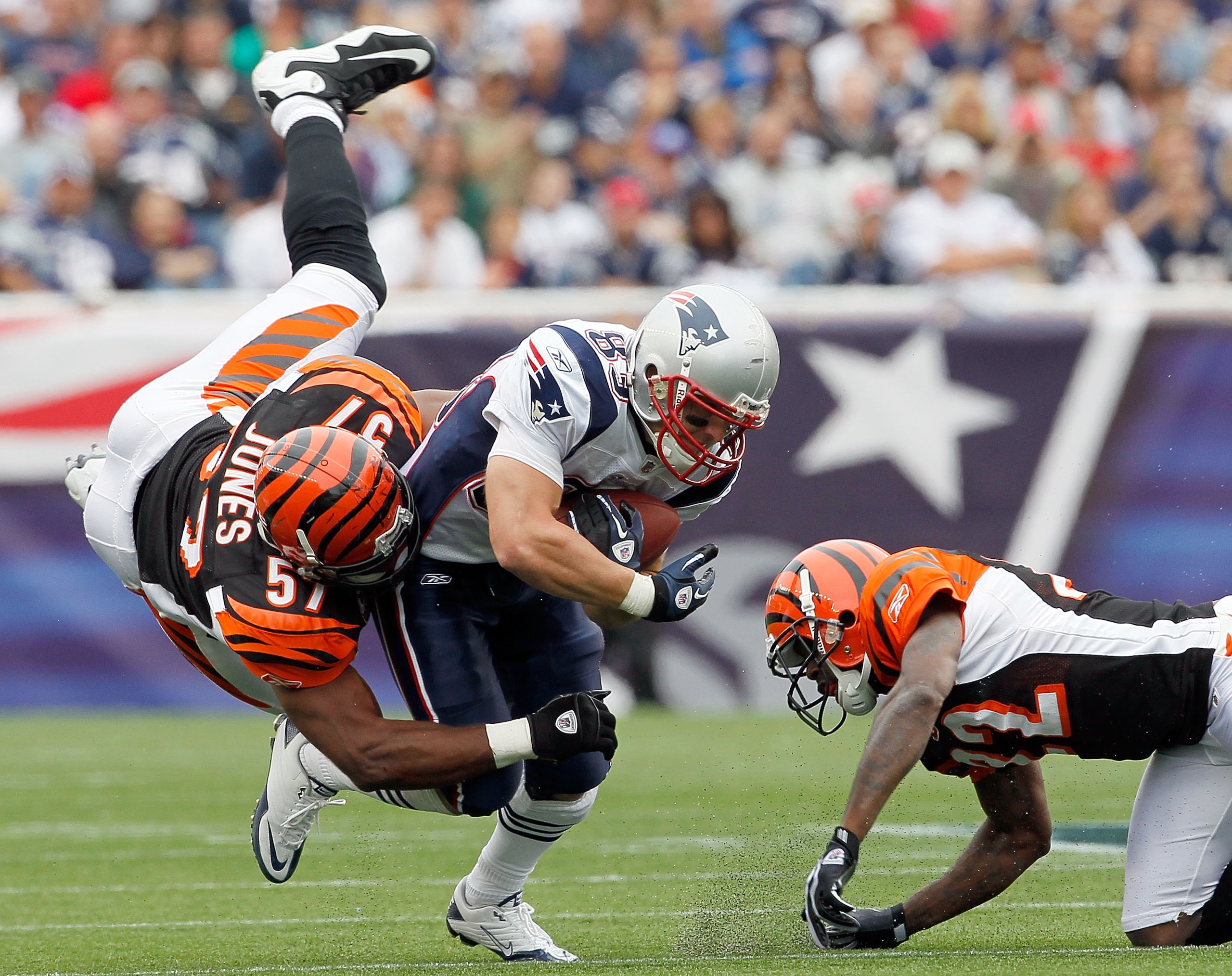 FOXBORO, MA - SEPTEMBER 12:  Wes Welker #83 of the New England Patriots gains yardage despite the defense of Dhani Jones #57 and Cedric Benson #32 of the Cincinnati Bengals during during the NFL season opener at Gillette Stadium on September 12, 2010 in F