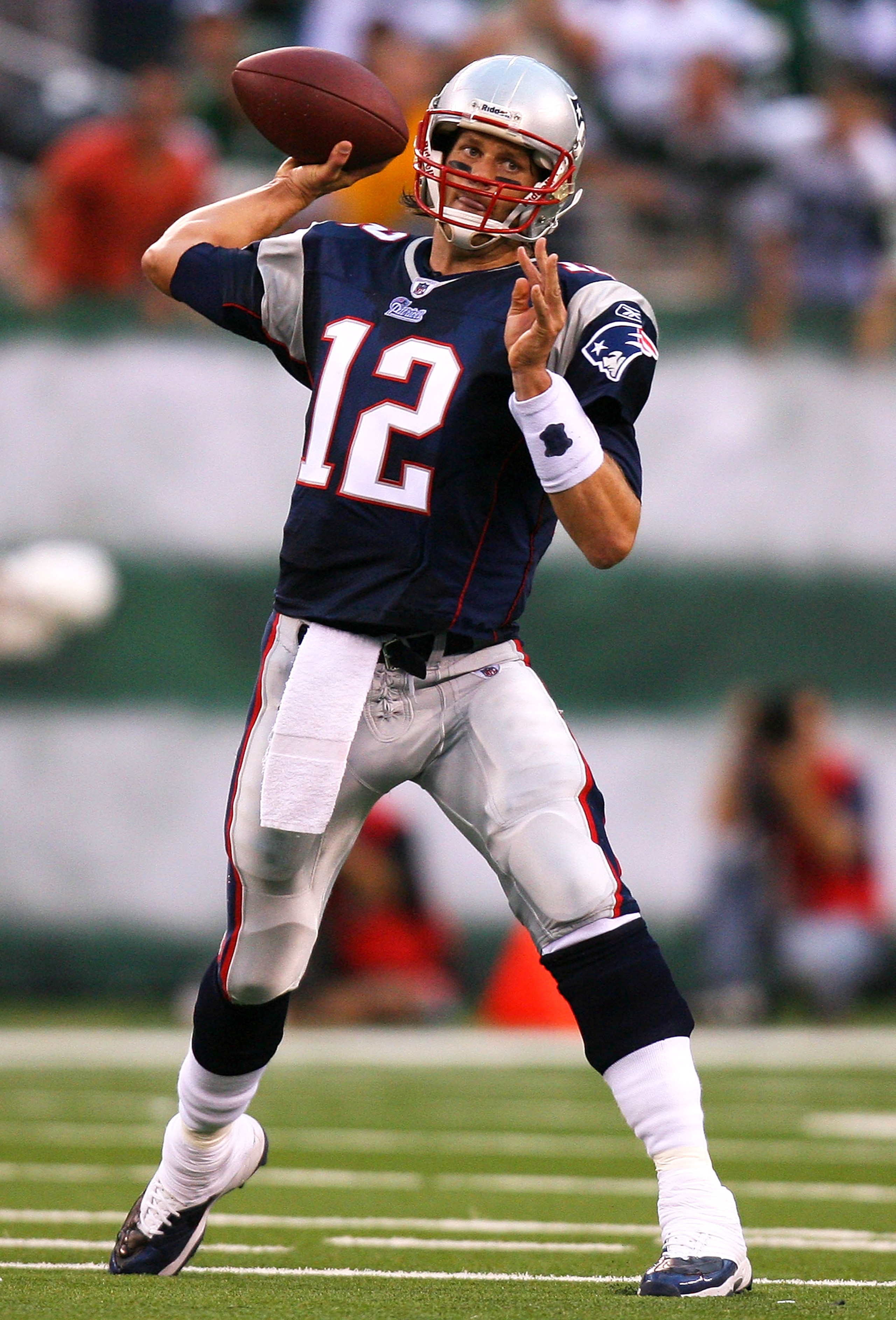 EAST RUTHERFORD, NJ - SEPTEMBER 19:  Tom Brady #12 of the New England Patriots drops passes against the New York Jets at the New Meadowlands Stadium on September 19, 2010 in East Rutherford, New Jersey. The Jets defeated the Patriots 28 - 14.  (Photo by A