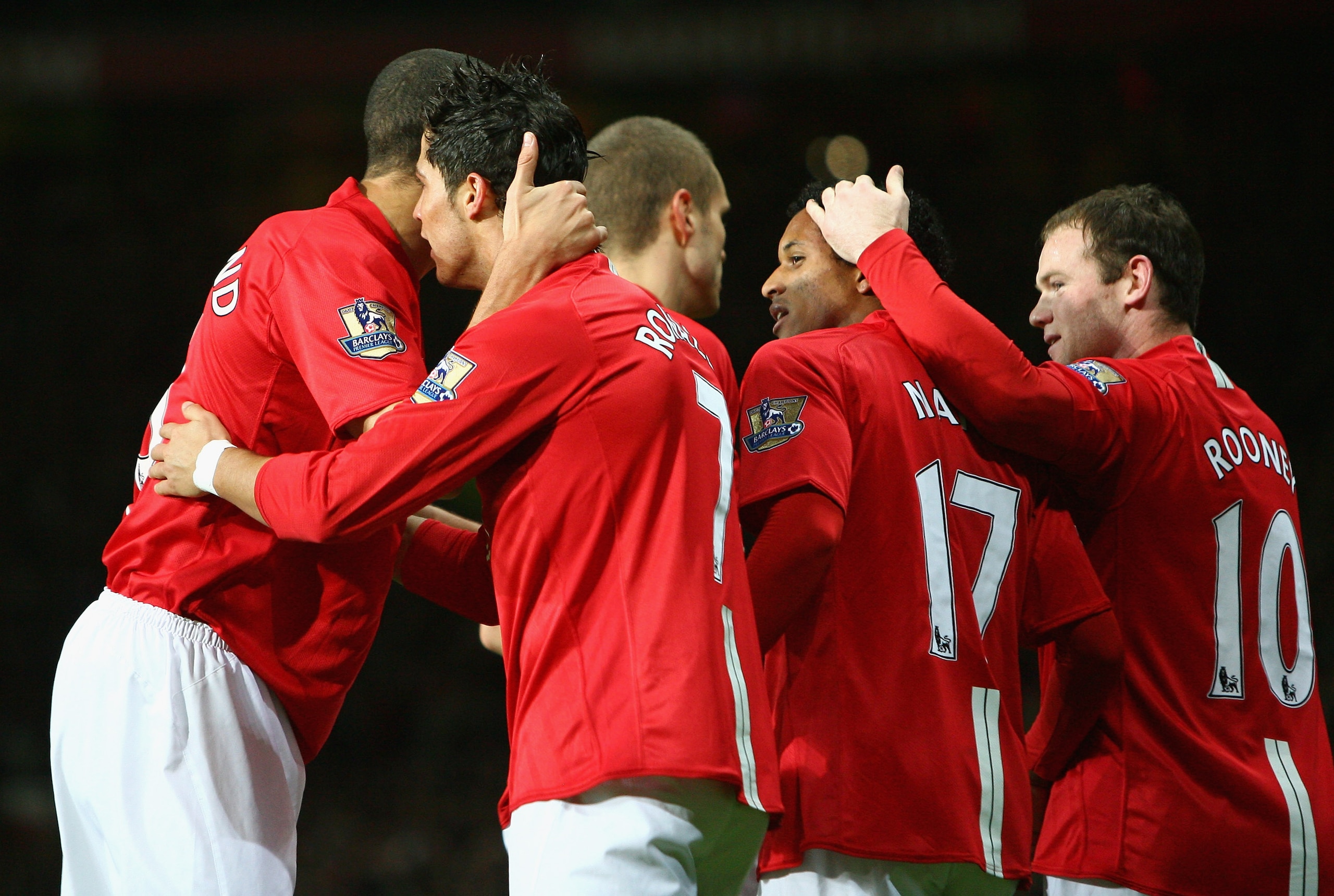 MANCHESTER, UNITED KINGDOM - JANUARY 30:  Cristiano Ronaldo of Manchester United is congratulated by his team mates after scoring the opening goal during the Barclays Premier League match between Manchester United and Portsmouth at Old Trafford on January