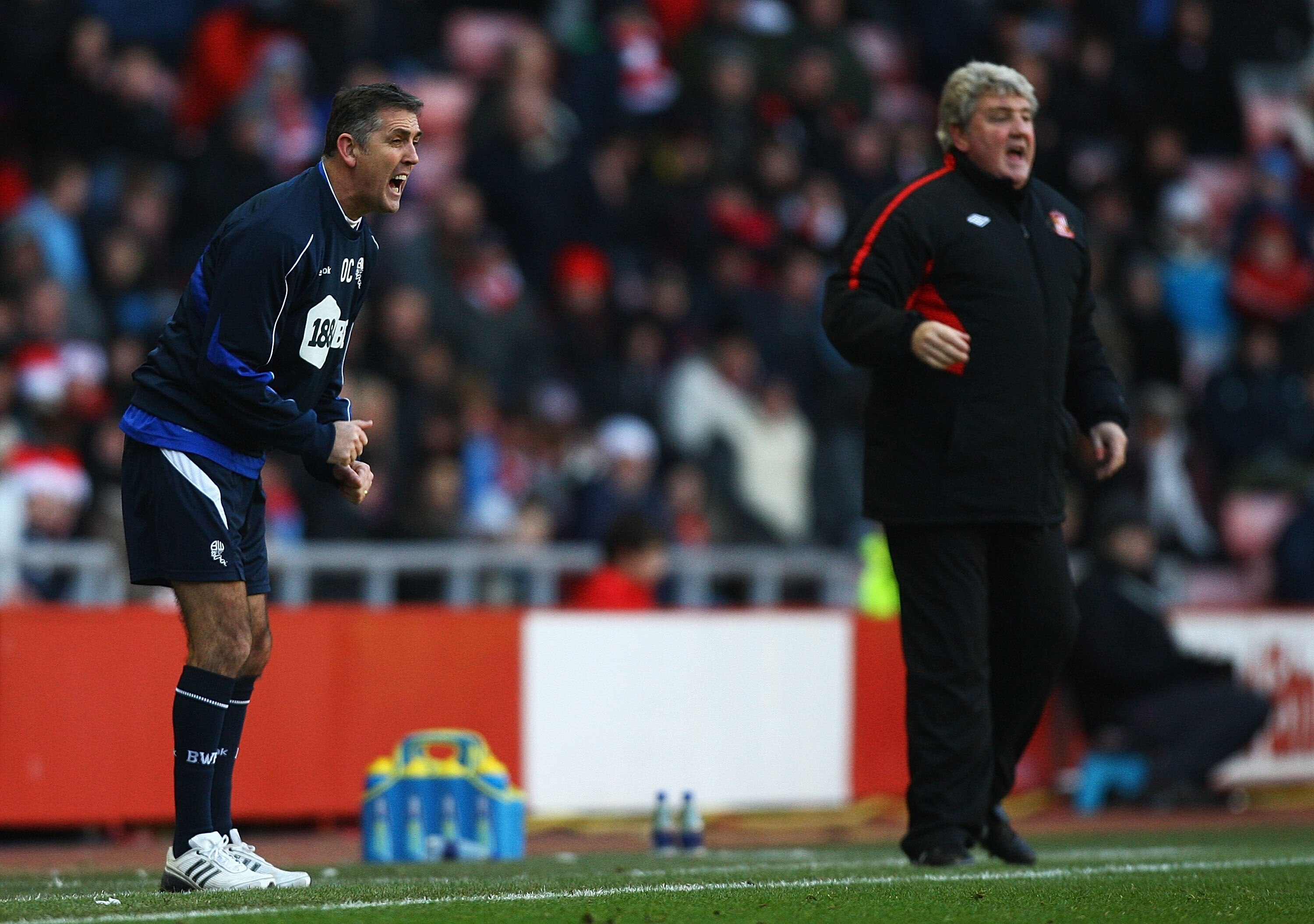 SUNDERLAND, ENGLAND - DECEMBER 18:  Owen Coyle, manager of Bolton Wanderers, gives out instructions, as Steve Bruce, manager of Sunderland, looks on during the Barclays Premier League match between Sunderland and Bolton Wanderers at Stadium of Light on De