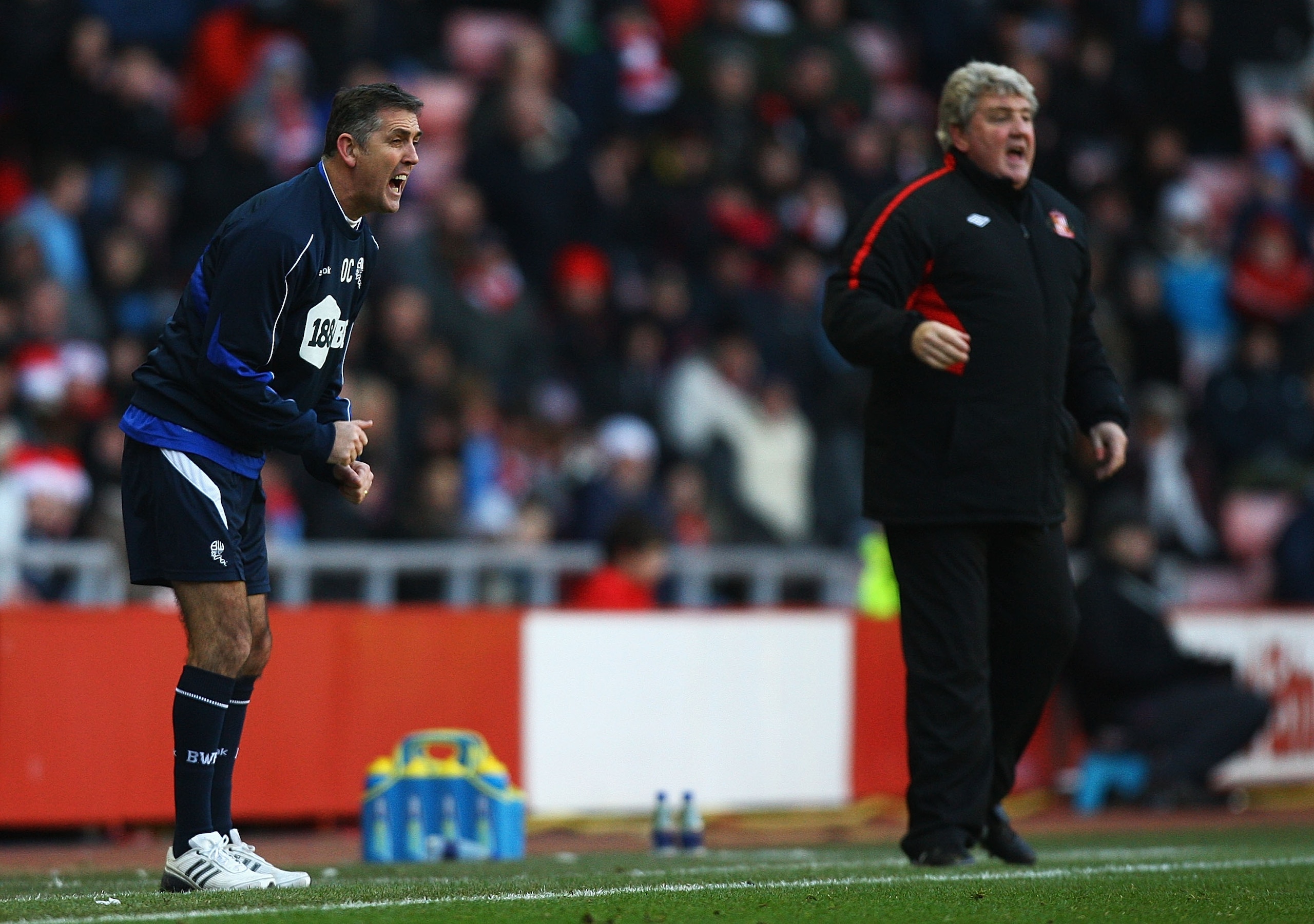 SUNDERLAND, ENGLAND - DECEMBER 18:  Owen Coyle, manager of Bolton Wanderers, gives out instructions, as Steve Bruce, manager of Sunderland, looks on during the Barclays Premier League match between Sunderland and Bolton Wanderers at Stadium of Light on De
