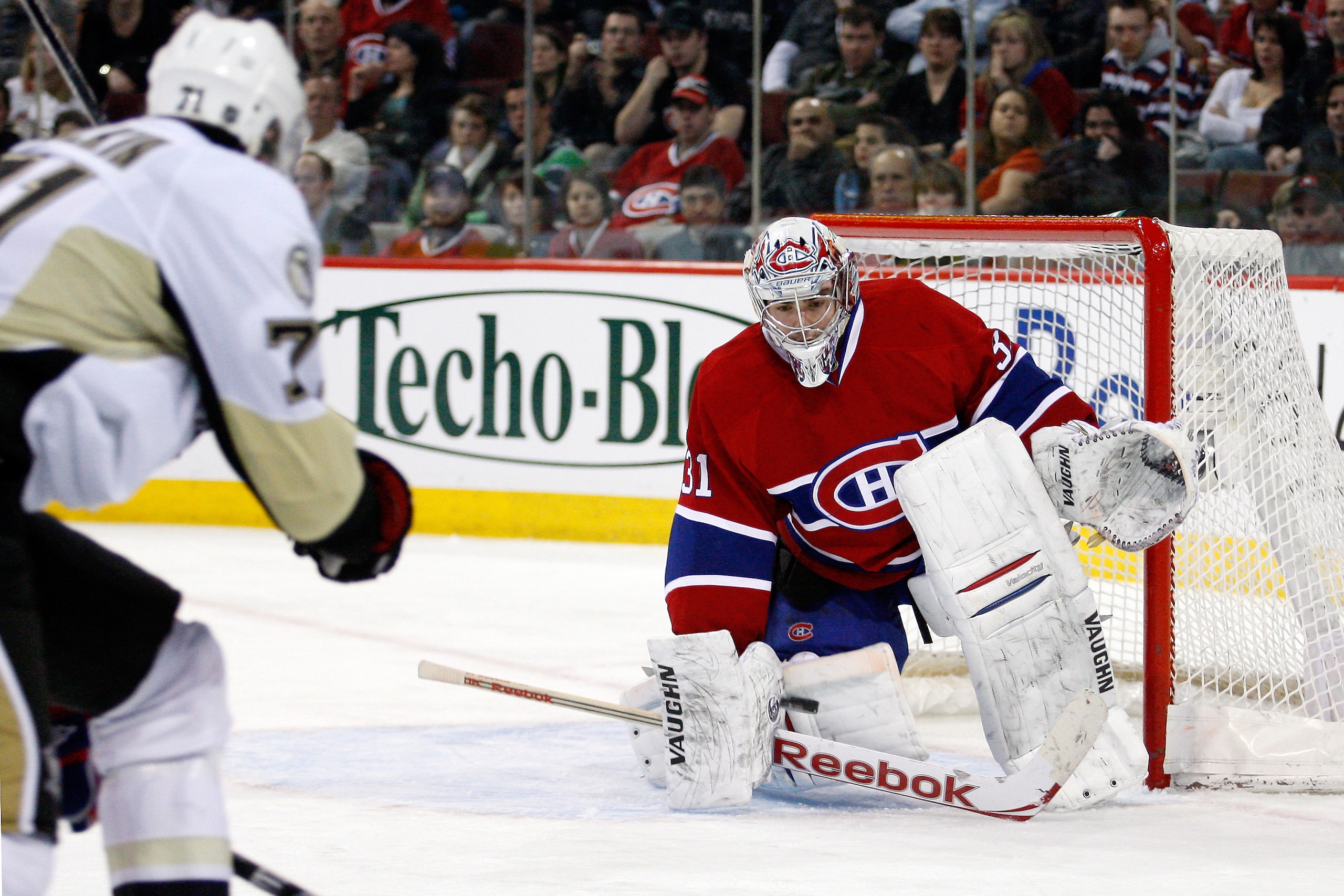 MONTREAL, CANADA - JANUARY 12:  Carey Price #31 of the Montreal Canadiens gets down to stop the incoming puck on a shot by Evgeni Malkin #71 of the Pittsburgh Penguins during the NHL game at the Bell Centre on January 12, 2011 in Montreal, Quebec, Canada.