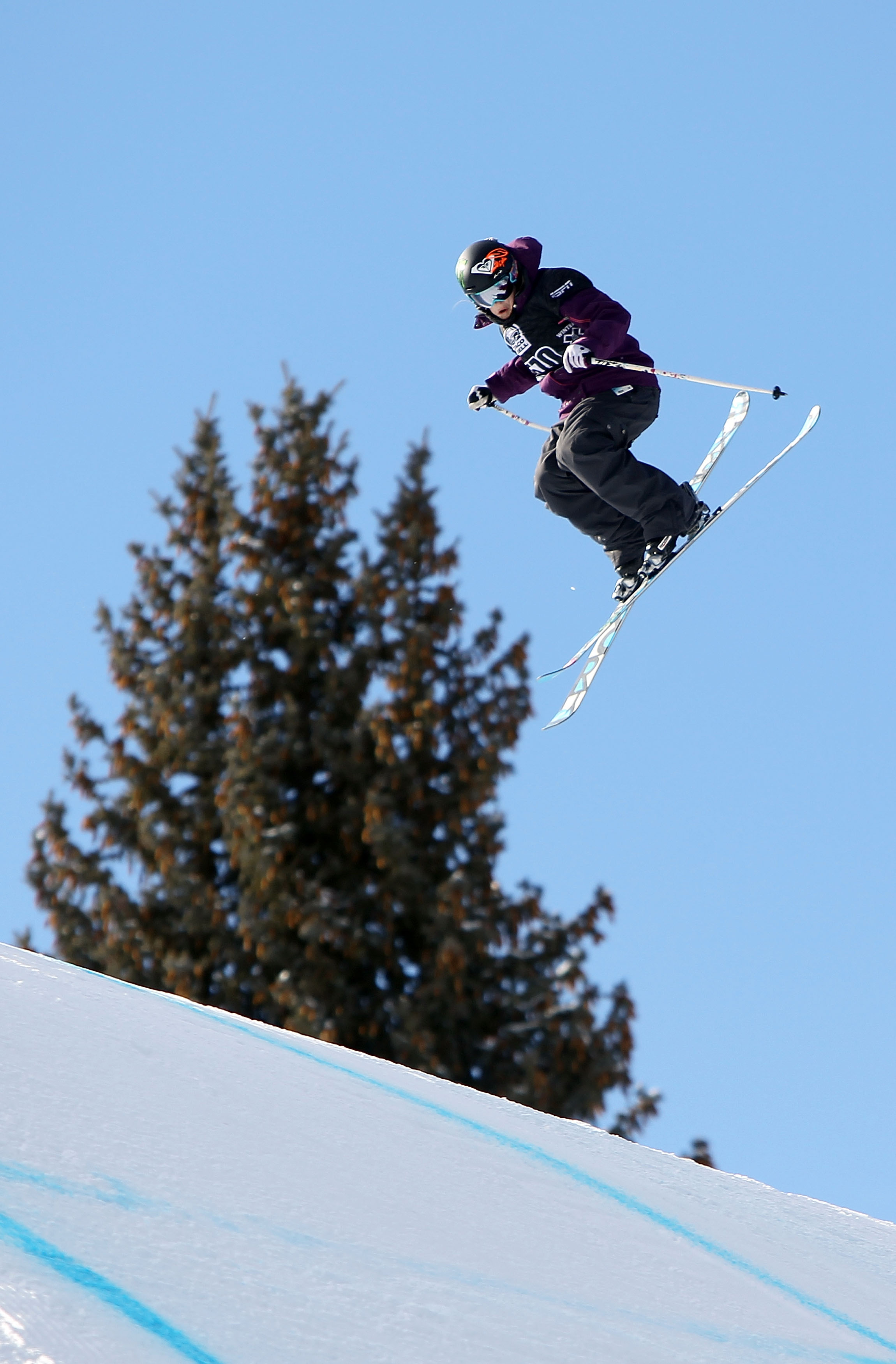 ASPEN, CO - JANUARY 28:  Sarah Burke of Canada does an aerial maneuver as she descends the course to finish sixth in the Women's Skiing Slopestyle Finals during Winter X Games 14 at Buttermilk Mountain on January 28, 2010 in Aspen, Colorado.  (Photo by Do