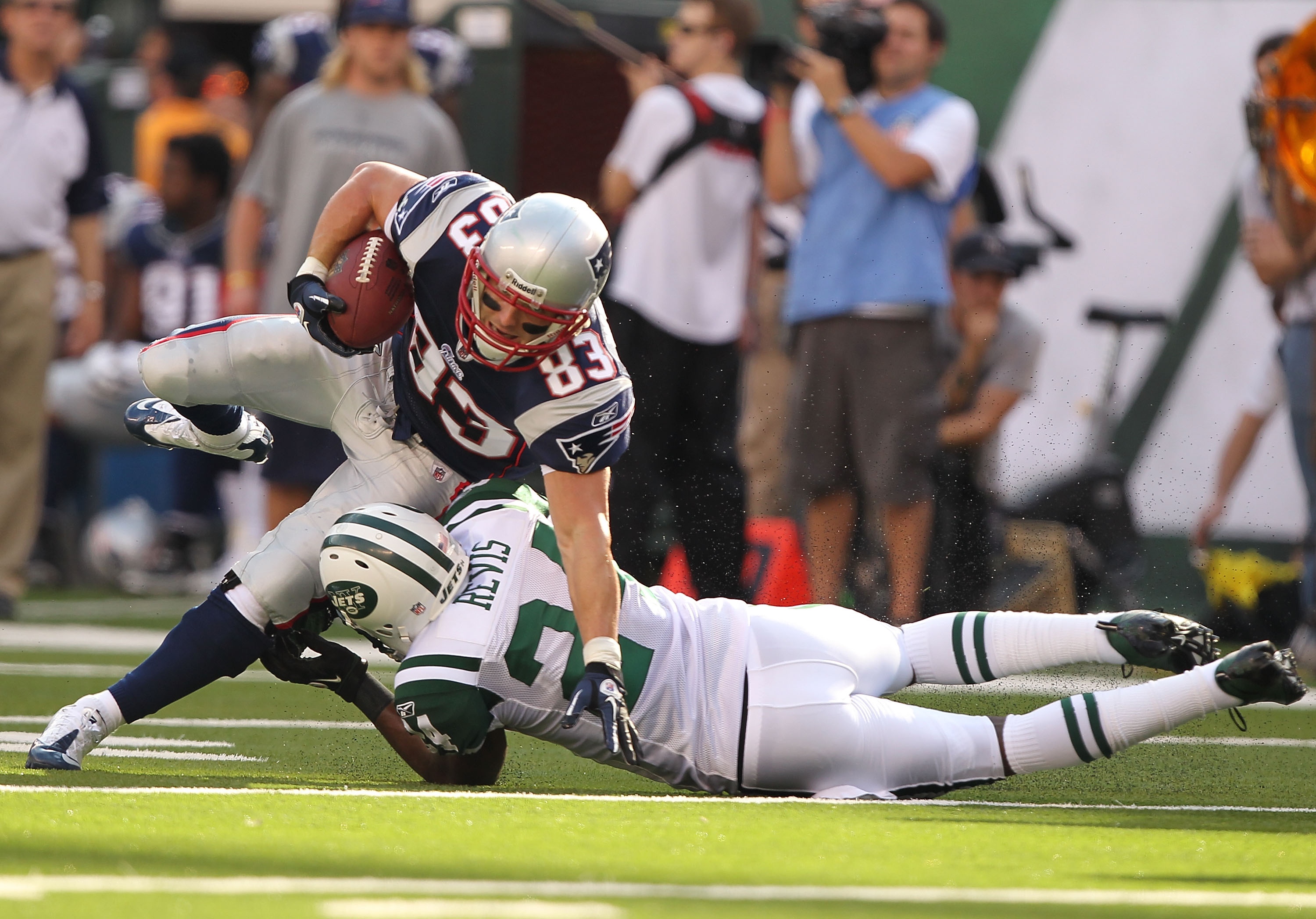 EAST RUTHERFORD, NJ - SEPTEMBER 19:  Darrelle Revis #24 of the New York Jets tackles Wes Welker #83 of the New England Patriots during their  game on September 19, 2010 at the New Meadowlands Stadium  in East Rutherford, New Jersey.  (Photo by Al Bello/Ge