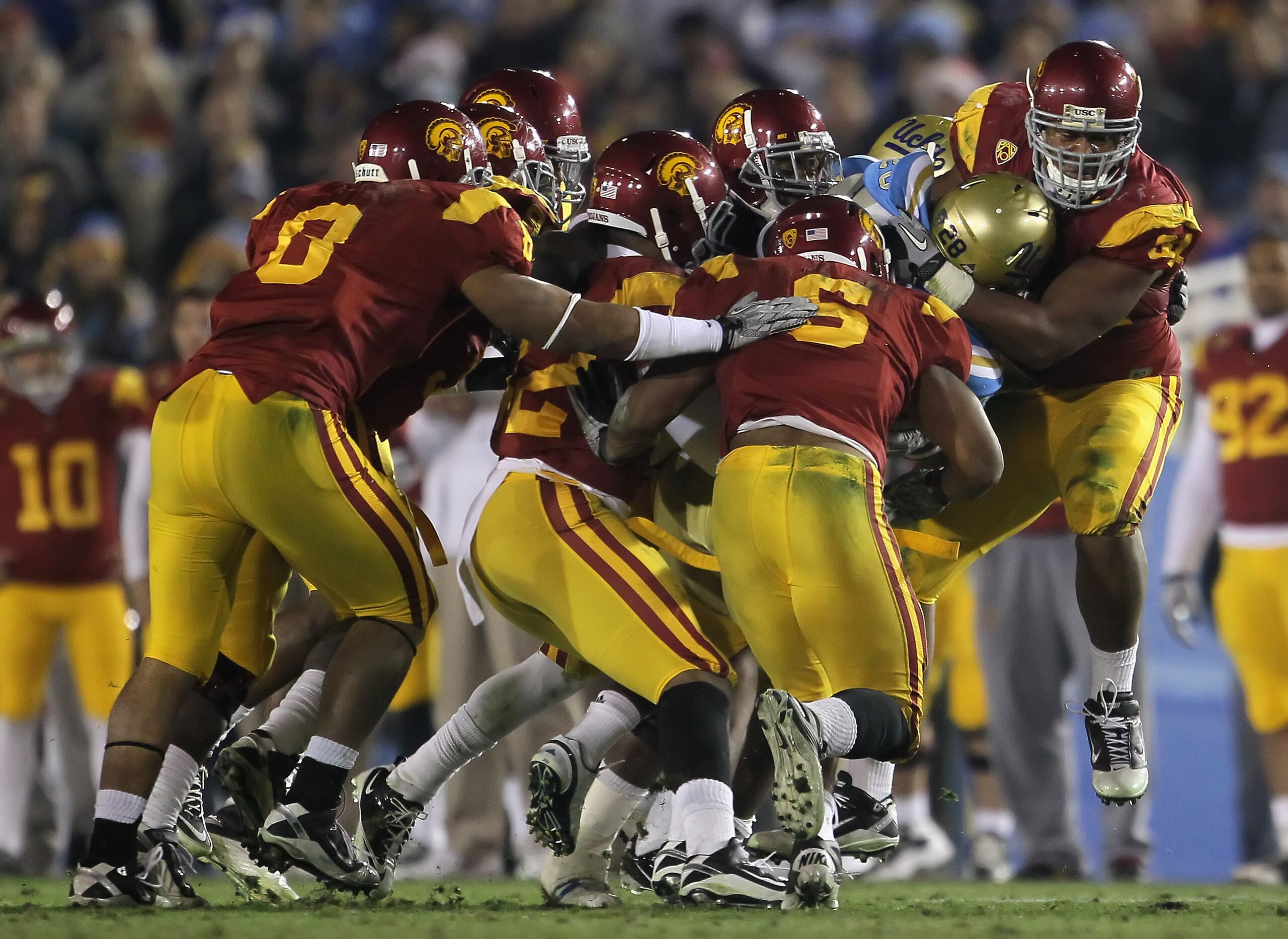 PASADENA, CA - DECEMBER 04: Chris Galippo (R) #54 of the USC Trojans tackles Malcolm Jones #28 of the UCLA Bruins during the second half at the Rose Bowl on December 4, 2010 in Pasadena, California. USC defeated UCLA 28-14. (Photo by Jeff Gross/Getty Im PASADENA, CA - DECEMBER 04: Chris Galippo (R) #54 of the USC Trojans tackles Malcolm Jones #28 of the UCLA Bruins during the second half at the Rose Bowl on December 4, 2010 in Pasadena, California. USC defeated UCLA 28-14. (Photo by Jeff Gross/Getty Im