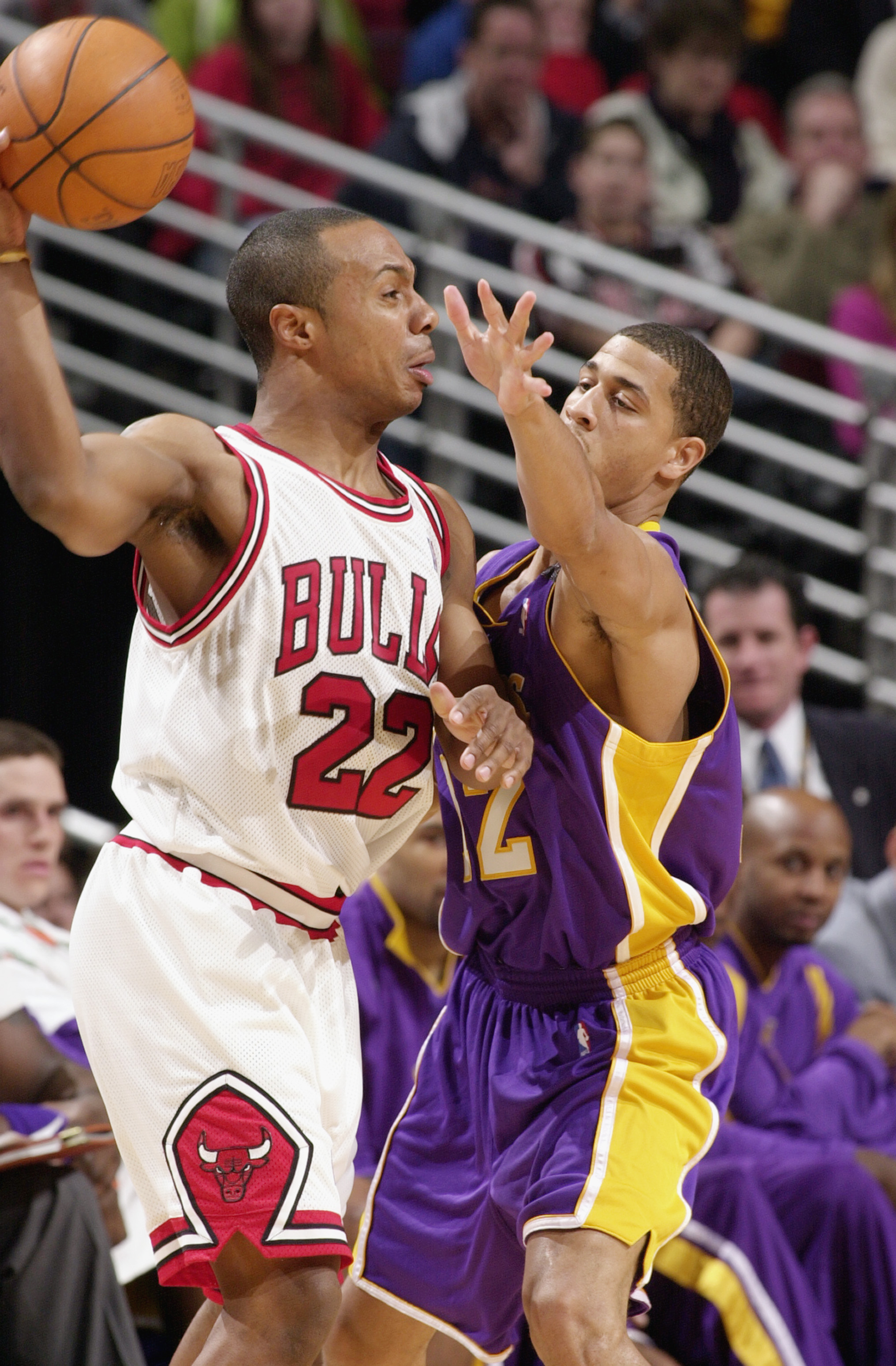 CHICAGO - MARCH 11:  Jay Williams #22 of the Chicago Bulls attempts to pass around Jannero Pargo #12 of the Los Angeles Lakers during the game at the United Center on March 11, 2003 in Chicago, Illinois.  The Bulls won 116-99.  NOTE TO USER: User expressl