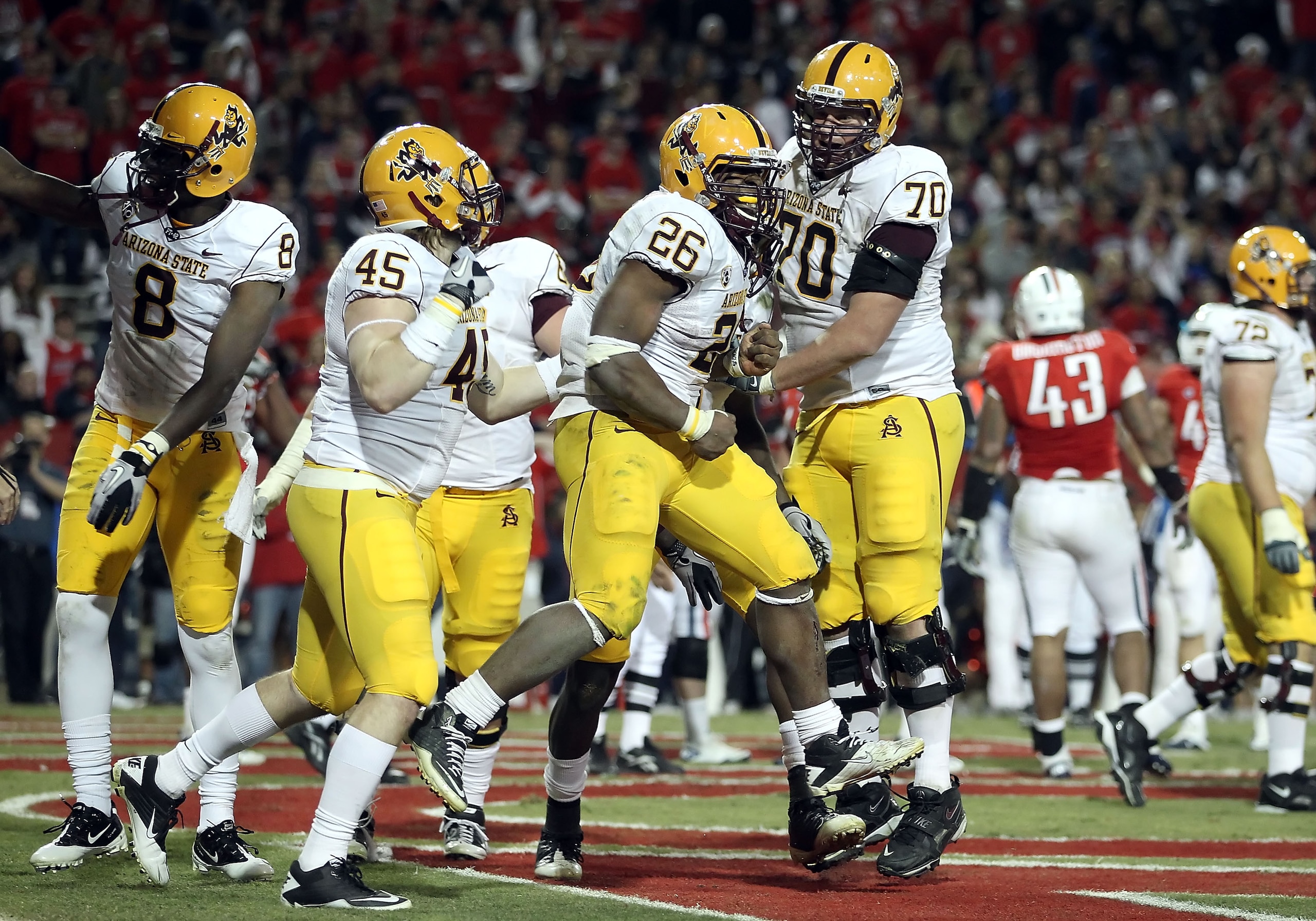 TUCSON, AZ - DECEMBER 02: Runningback Cameron Marshall #26 of the Arizona State Sun Devils scores a rushing touchdown during the college football game at Arizona Stadium on December 2, 2010 in Tucson, Arizona. The Sun Devils defeated the Wildcats 30-29 i TUCSON, AZ - DECEMBER 02: Runningback Cameron Marshall #26 of the Arizona State Sun Devils scores a rushing touchdown during the college football game at Arizona Stadium on December 2, 2010 in Tucson, Arizona. The Sun Devils defeated the Wildcats 30-29 i