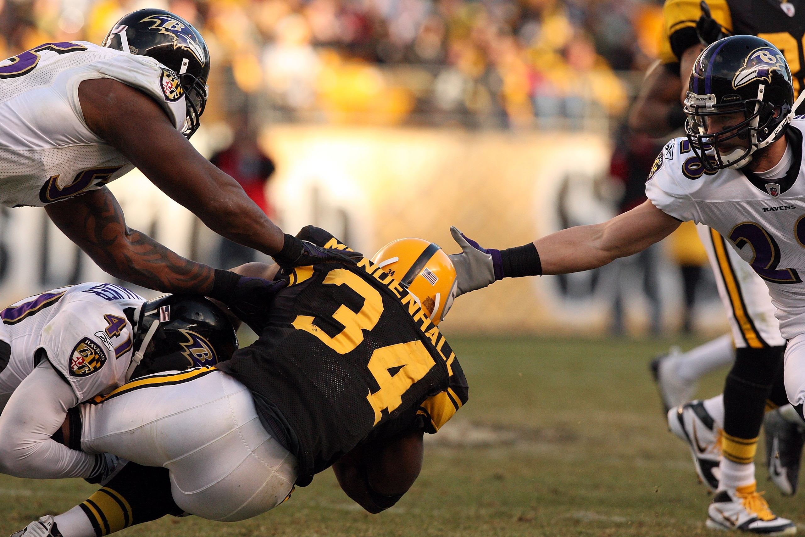 PITTSBURGH - DECEMBER 27:  Rashard Mendenhall #34 of the Pittsburgh Steelers is tackled by Frank Walker #41 of the Baltimore Ravens during the game at Heinz Field on December 27, 2009 in Pittsburgh, Pennsylvania.  Pittsburgh won the game, 23-20. (Photo by