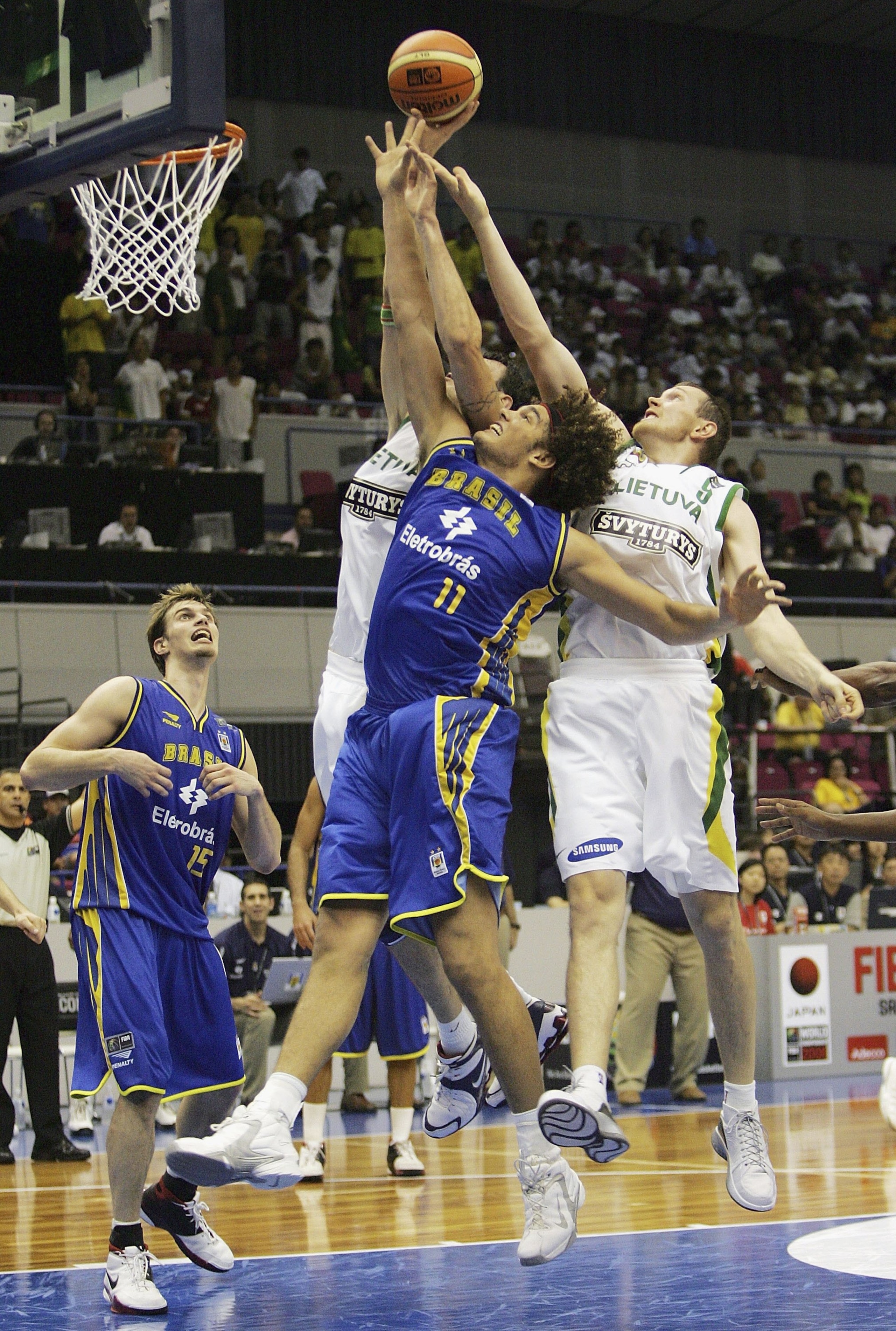 HAMAMATSU, JAPAN - AUGUST 24: Anderson Varejo of Brazil reaches for the ball against Lithuania during the preliminary round of FIBA World Championships 2006 on August 24, 2006 in Hamamatsu, Japan. The Championships take place from August 19 to September 3 HAMAMATSU, JAPAN - AUGUST 24: Anderson Varejo of Brazil reaches for the ball against Lithuania during the preliminary round of FIBA World Championships 2006 on August 24, 2006 in Hamamatsu, Japan. The Championships take place from August 19 to September 3