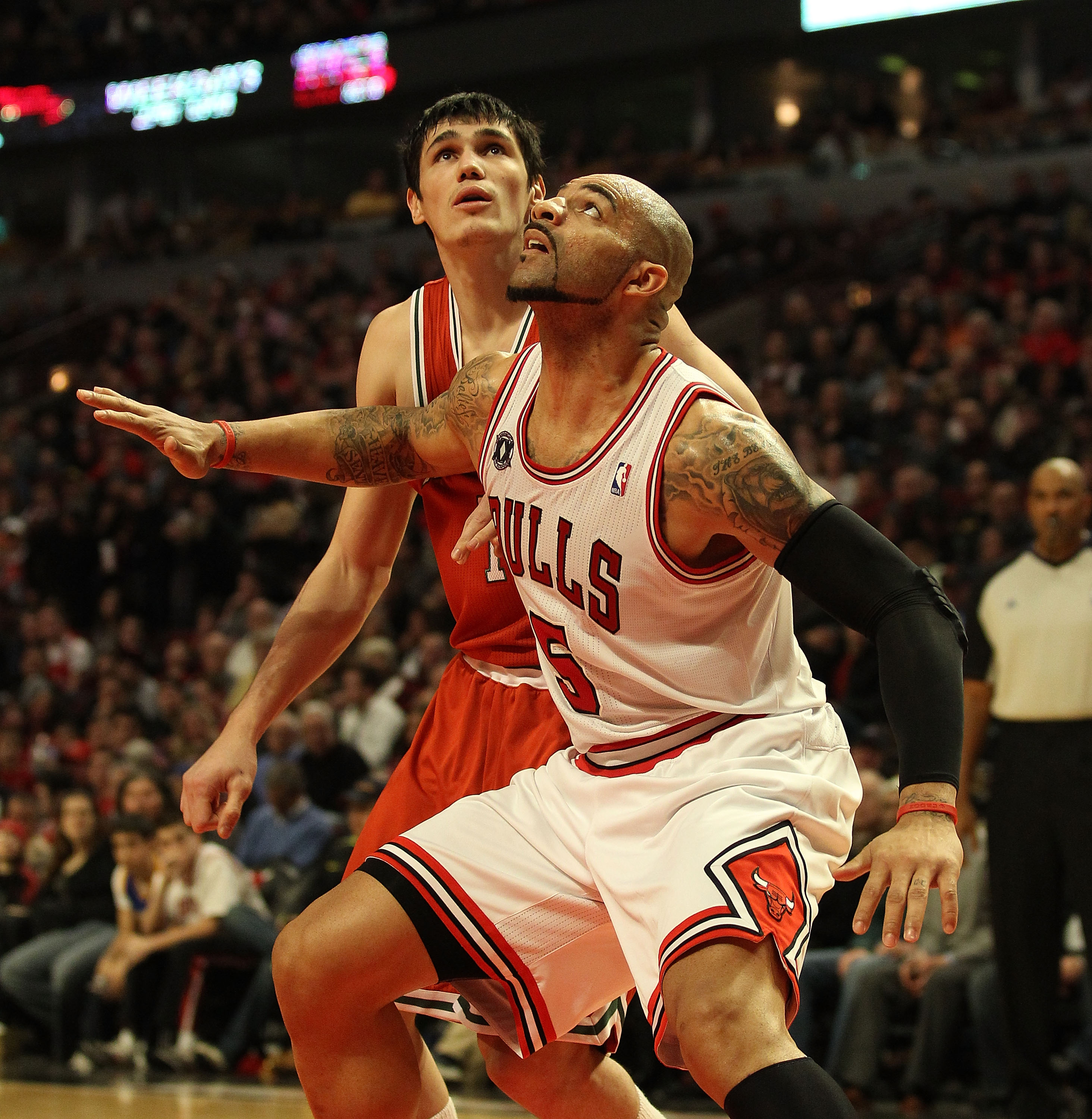 CHICAGO, IL - DECEMBER 28: Carlos Boozer #5 of the Chicago Bulls screens Ersan Ilyasova #7 of the Milwaukee Bucks at the United Center on December 28, 2010 in Chicago, Illinois. The Bulls defeated the Bucks 90-77. NOTE TO USER: User expressly acknowledges