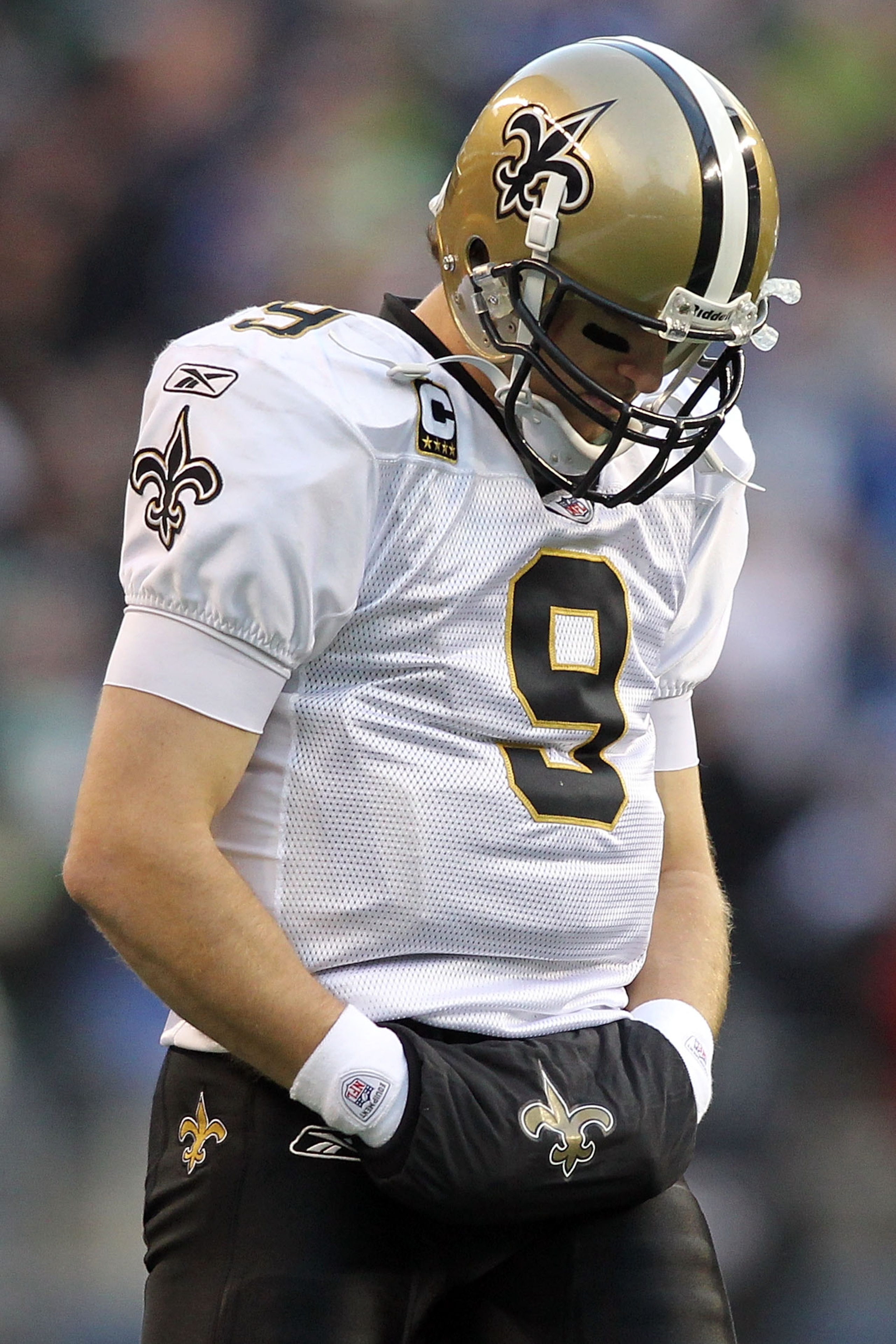 SEATTLE, WA - JANUARY 08:  Quarterback Drew Brees #9 of the New Orleans Saints looks dwon in the second half against the Seattle Seahawks during the 2011 NFC wild-card playoff game at Qwest Field on January 8, 2011 in Seattle, Washington.  (Photo by Jonat