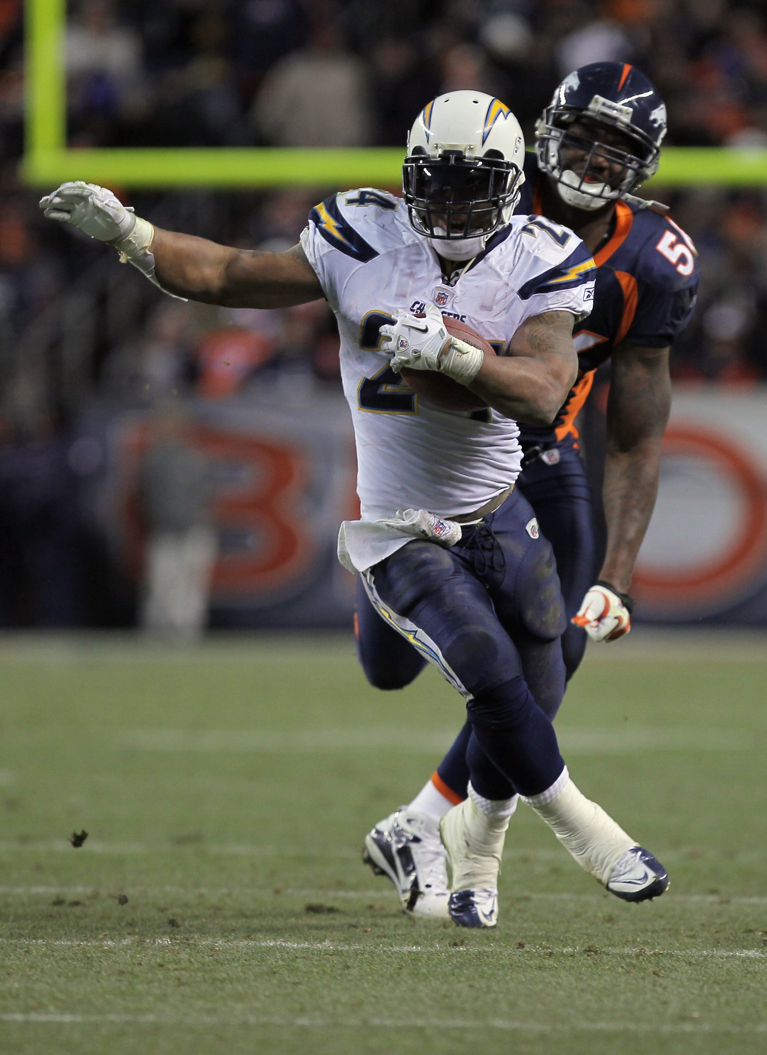 DENVER - JANUARY 02:  Running back Ryan Mathews #24 of the San Diego Chargers eludes linebacker Robert Ayers #56 of the Denver Broncos as he rushes for a 31 yard touchdown on fourth down and one yard to go in the fourth quarter at INVESCO Field at Mile Hi
