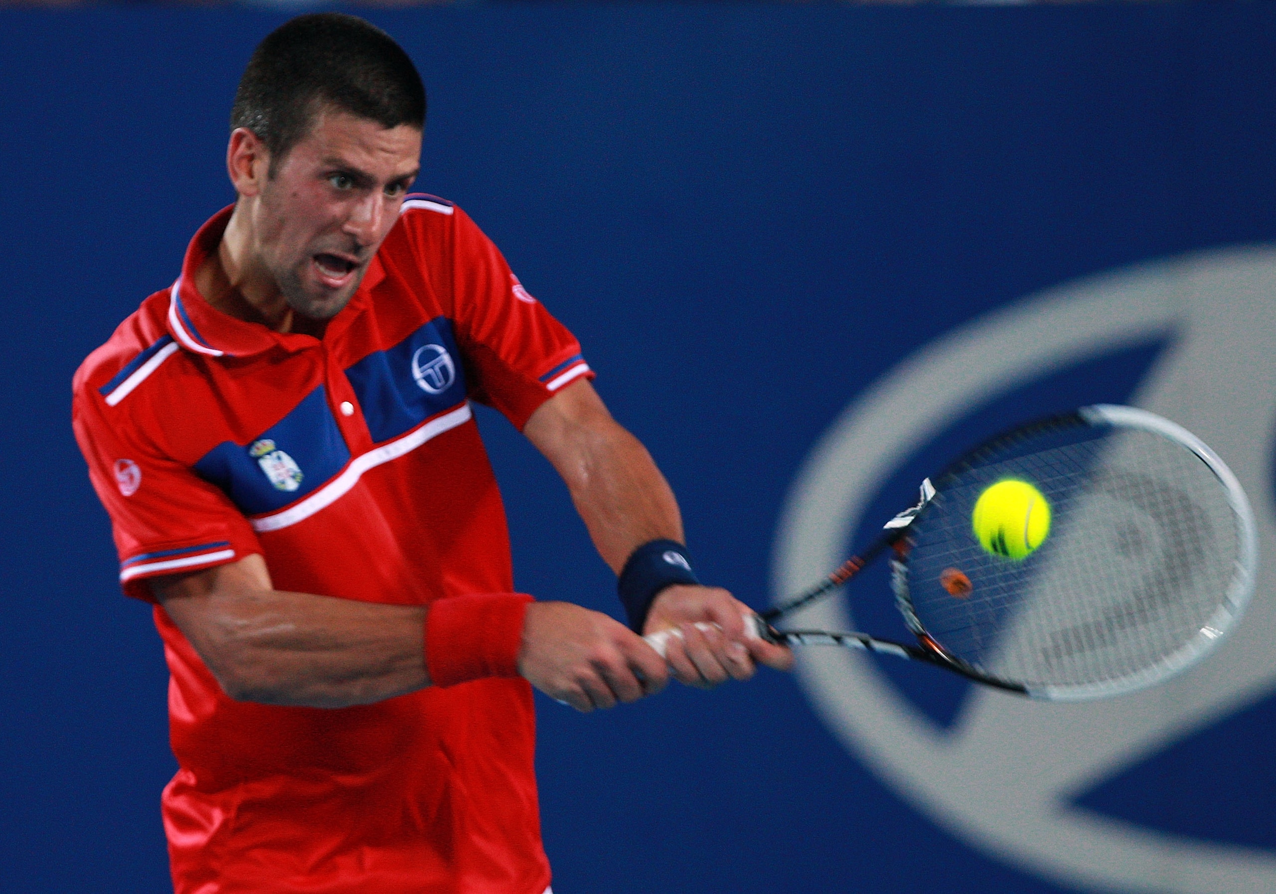 PERTH, AUSTRALIA - JANUARY 04:  Novak Djokovic of Serbia plays a return shot to Lleyton Hewitt of Australia during his singles match on day four of the Hopman Cup on January 4, 2011 in Perth, Australia.  (Photo by Paul Kane/Getty Images)