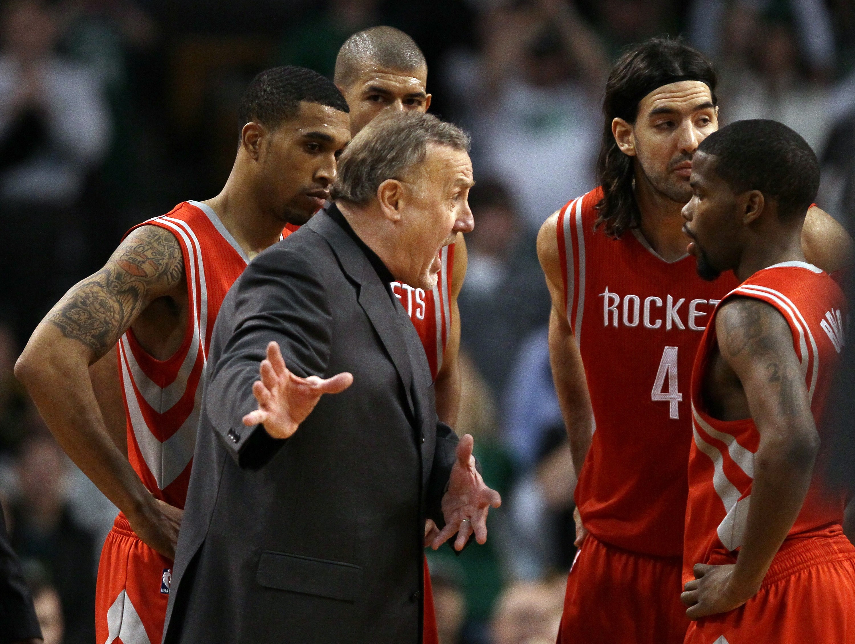 BOSTON, MA - JANUARY 10:  Head coach Rick Adelman of the Houston Rockets talks with Aaron Brooks #0 as Shane Battier #31,Kyle Lowry #7 and Luis Scola #4 stand by during a time out in the final seconds of the game against the Boston Celtics on January 10,