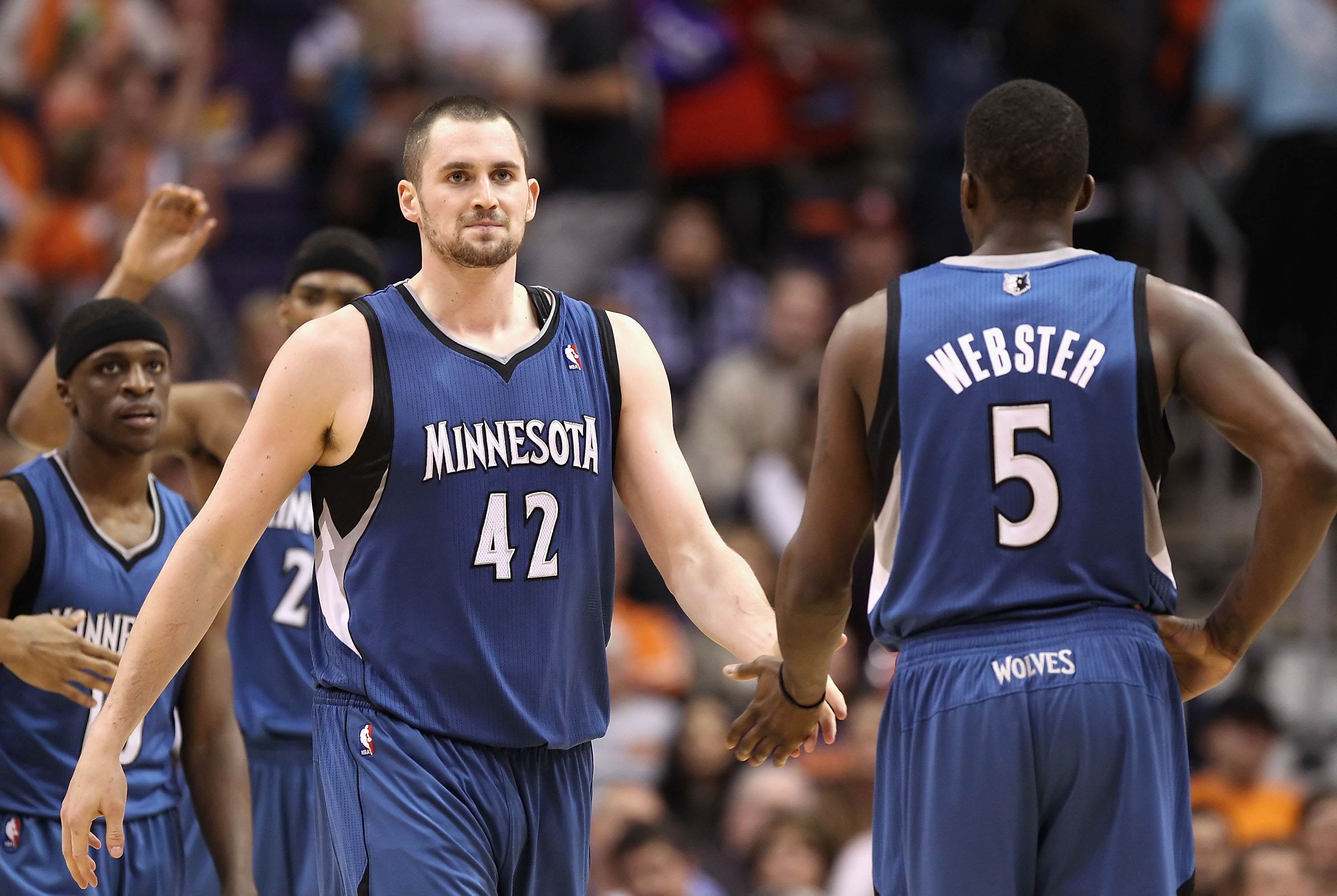 PHOENIX - DECEMBER 15:  Kevin Love #42 of the Minnesota Timberwolves high fives teammate Martell Webster #5 during the NBA game against the Phoenix Suns at US Airways Center on December 15, 2010 in Phoenix, Arizona.  The Suns defeated the Timberwolves 128