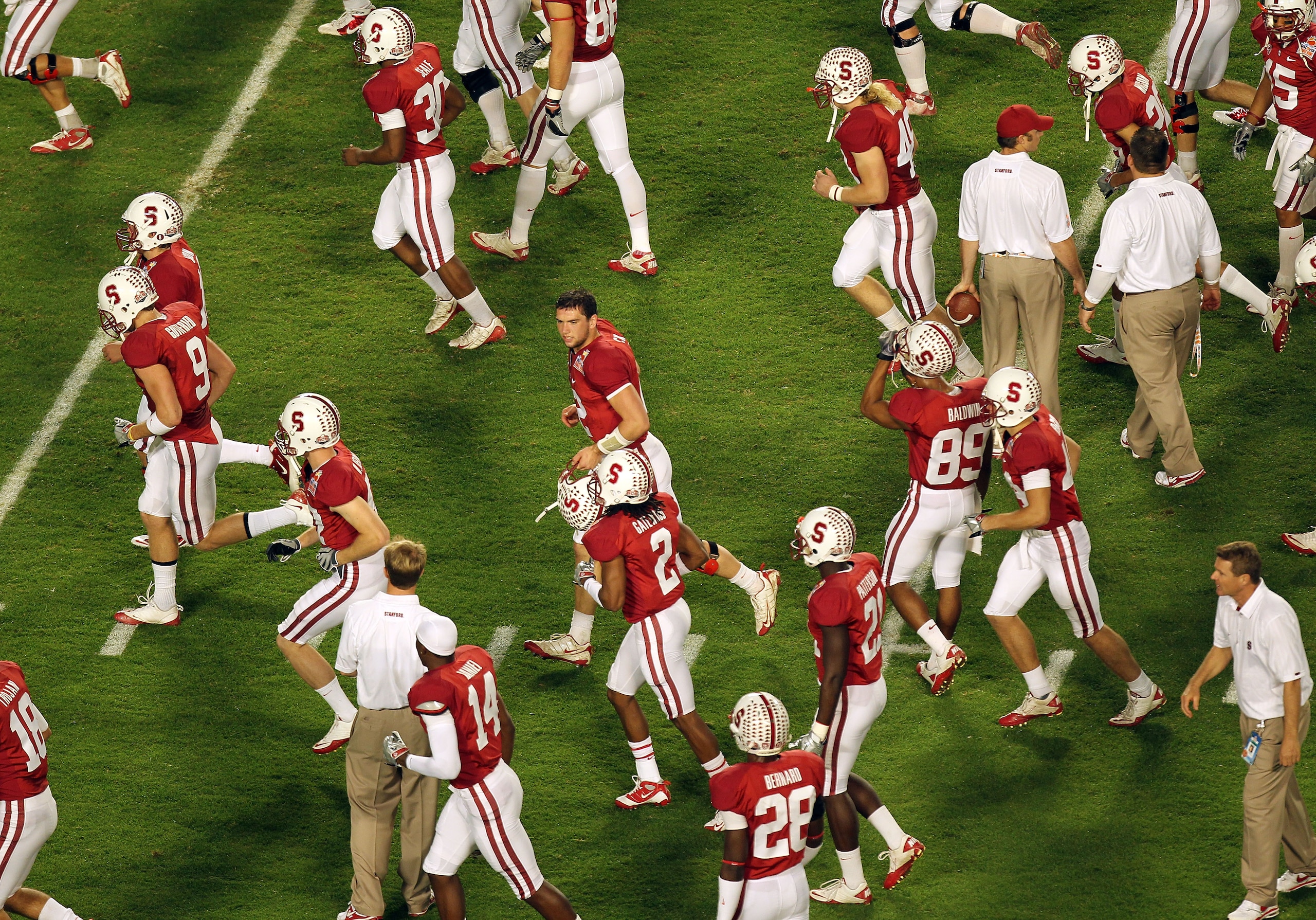 MIAMI, FL - JANUARY 03:  Quarterback Andrew Luck #12 (C with no helmet) of the Stanford Cardinal runs on the field with his teammates against the Virginia Tech Hokies during the 2011 Discover Orange Bowl at Sun Life Stadium on January 3, 2011 in Miami, Fl