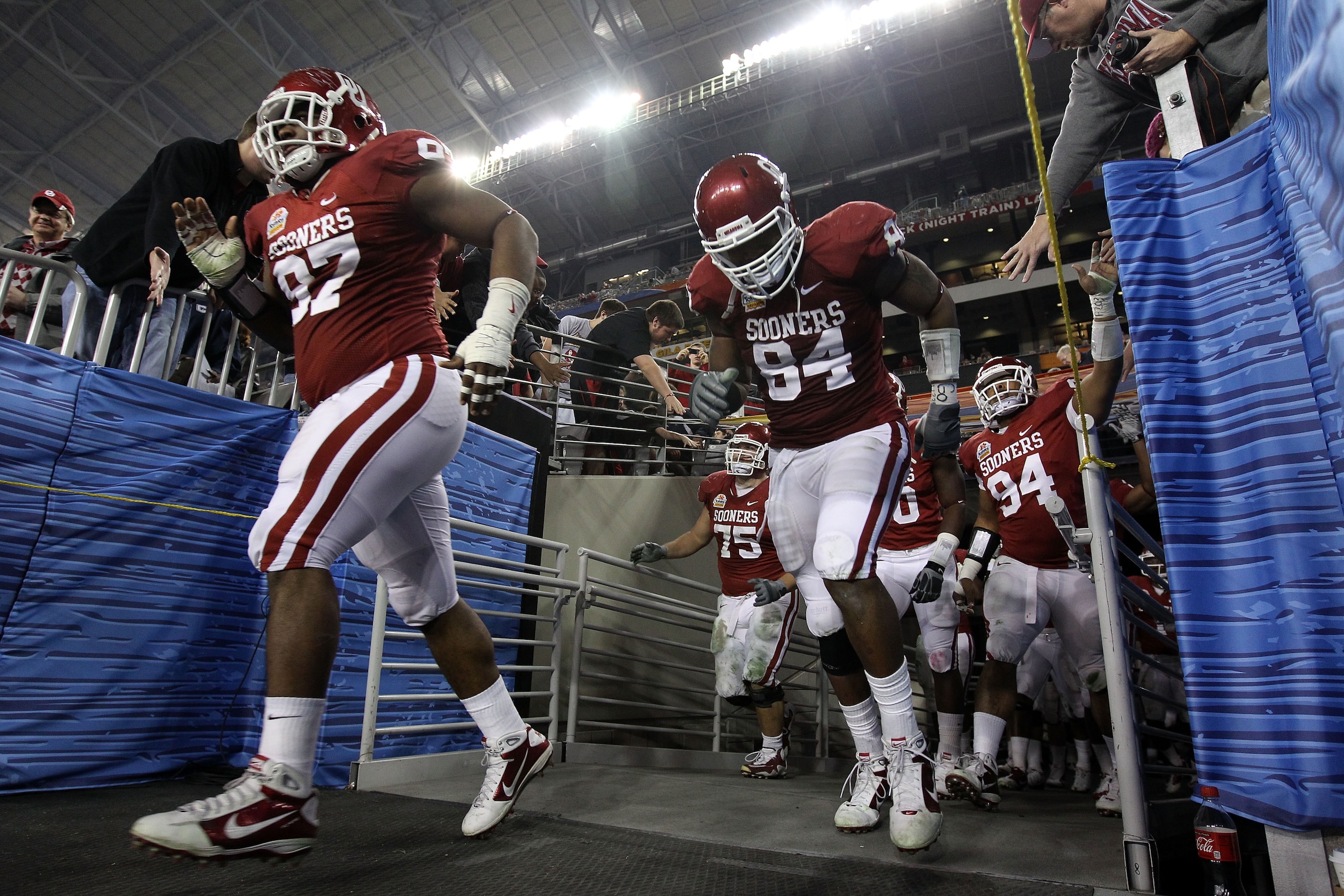 GLENDALE, AZ - JANUARY 01:  Jamarkus McFarland #97 and Pryce Macon #94 of the Oklahoma Sooners run out of the tunnel after the half to take on the Connecticut Huskies  during the Tostitos Fiesta Bowl at the Universtity of Phoenix Stadium on January 1, 201