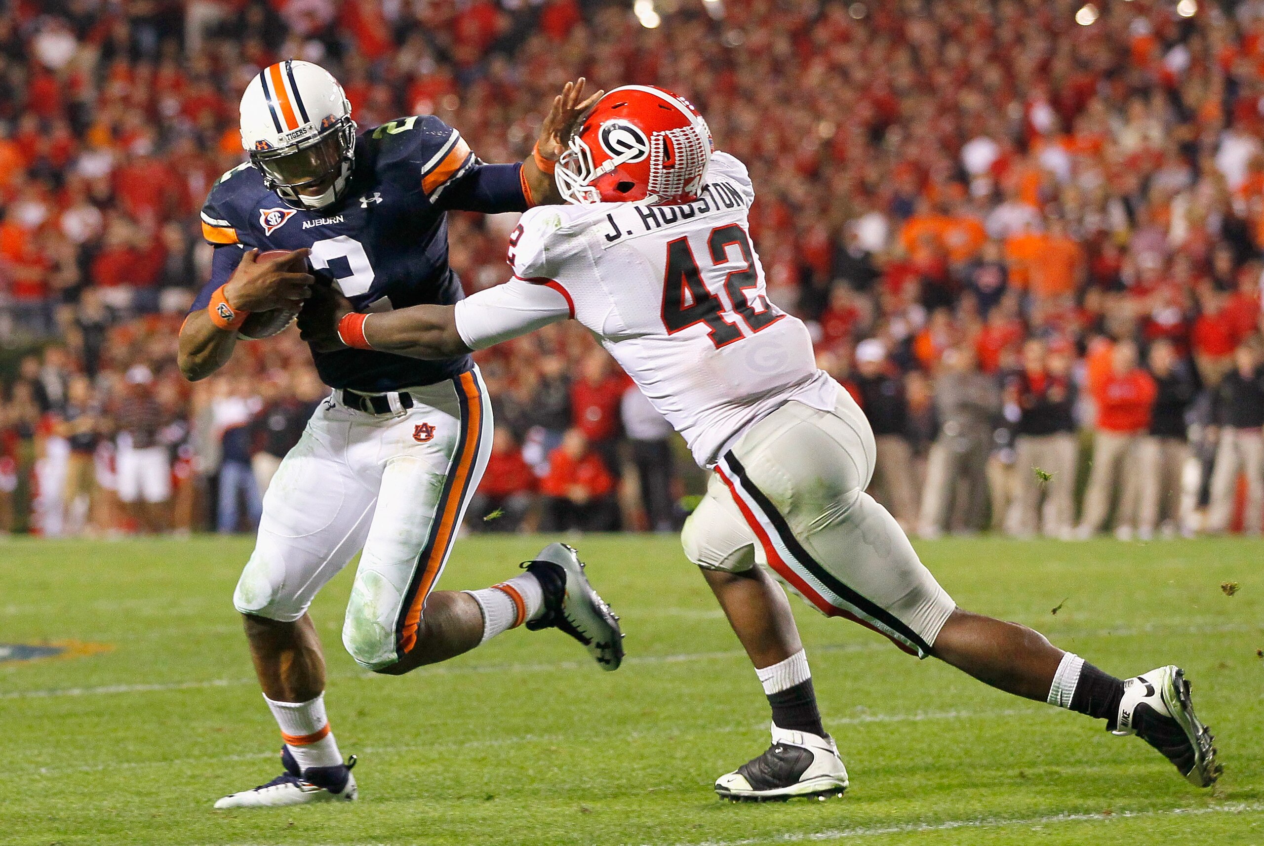 AUBURN, AL - NOVEMBER 13:  Quarterback Cameron Newton #2 of the Auburn Tigers breaks a tackle by Justin Houston #42 of the Georgia Bulldogs at Jordan-Hare Stadium on November 13, 2010 in Auburn, Alabama.  (Photo by Kevin C. Cox/Getty Images)