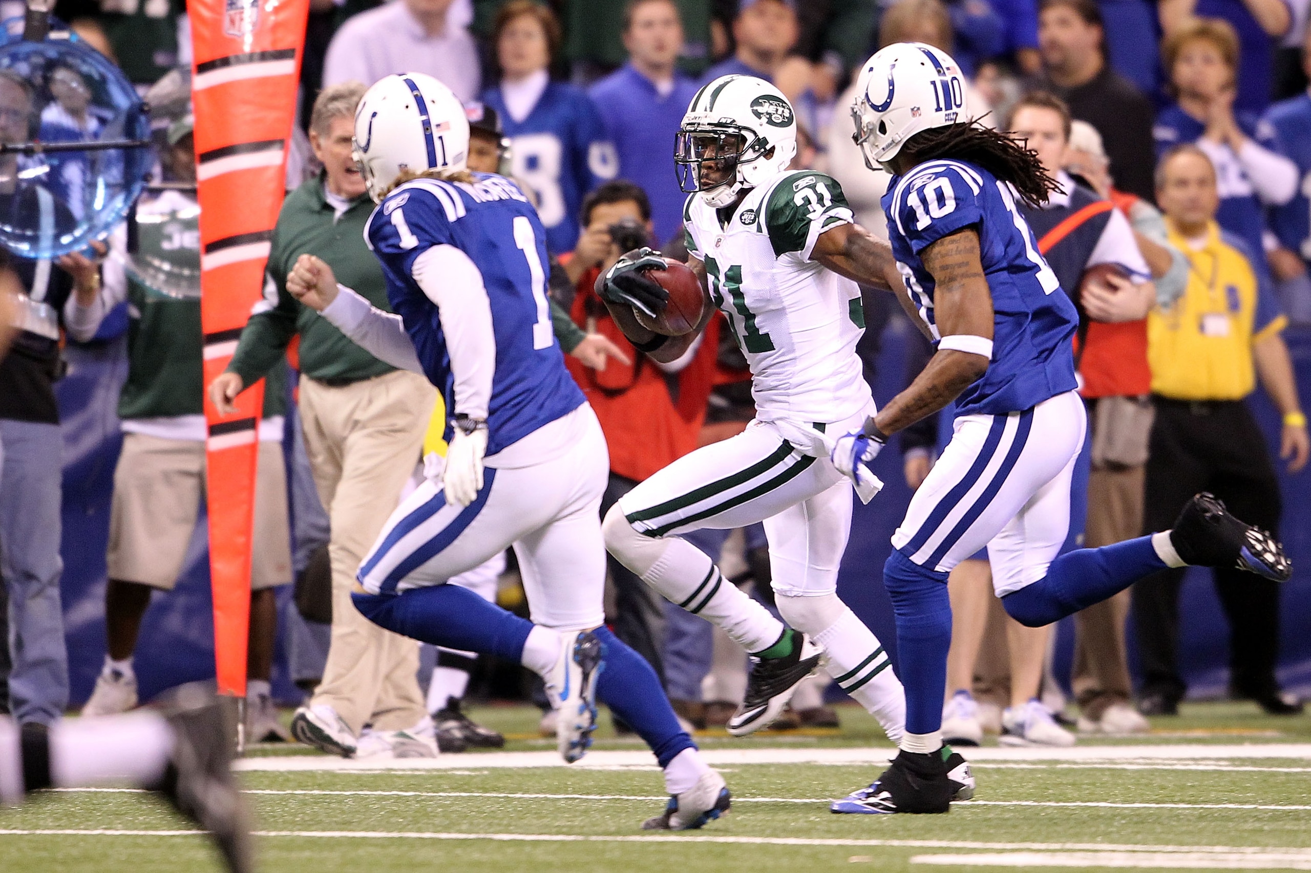 INDIANAPOLIS, IN - JANUARY 08:  Antonio Cromartie #31 of the New York Jets returns a kickoff 47-yards in the final minute of the fourth quarter against kicker Pat McAfee #1 of the Indianapolis Colts during their 2011 AFC wild card playoff game at Lucas Oi